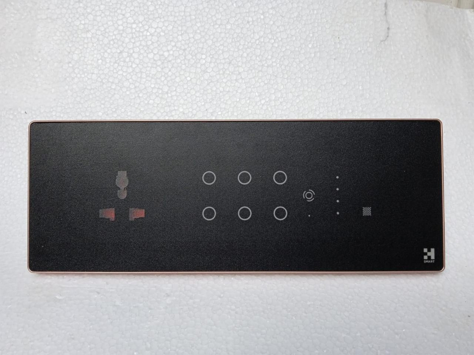 H-SMART touch panel in matte black with rose-gold trim -- six-point capacitive controls, universal socket, and scene access for elegant, intuitive home automation