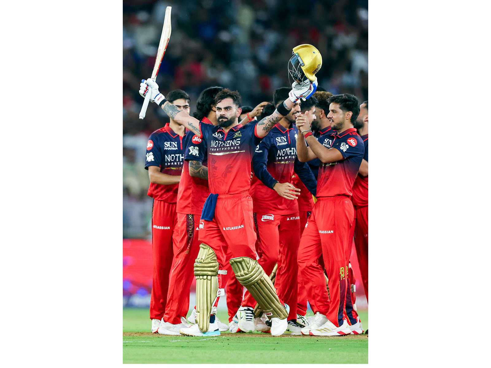 RCB's Virat Kohli (front) with team celebrating the final's victory (Photo: ANI)