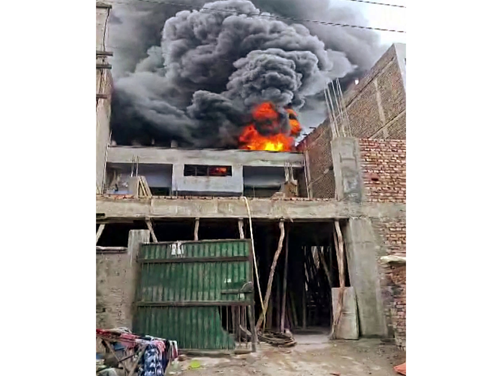 Smoke and flames billow out as fire breaks out in plastic factory in Narela Industrial Area, in Delhi (Photo/ANI)