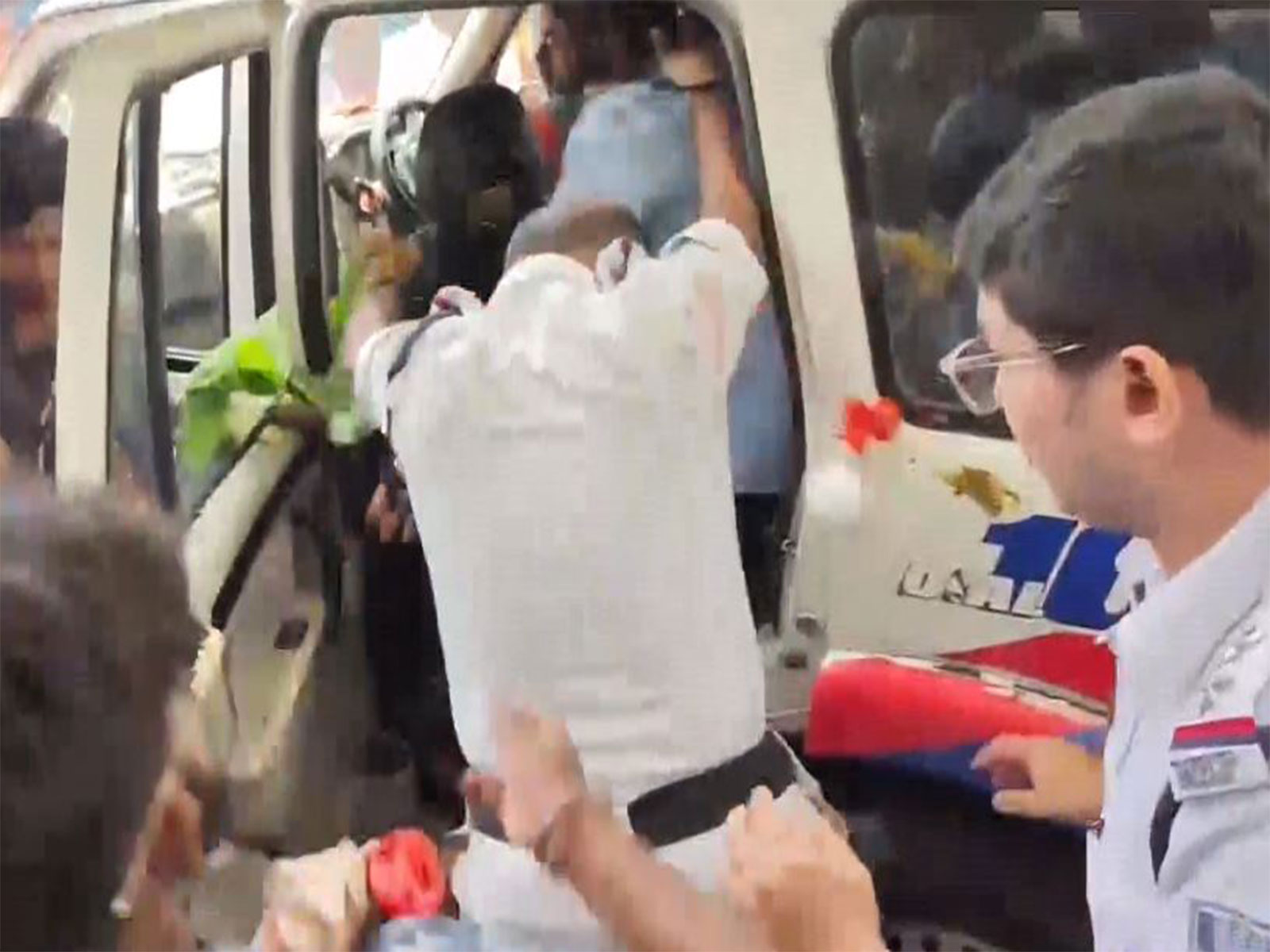 Police shield former Bidhannagar Mayor Sabyasachi Dutta as eggs and tomatoes are hurled at him while he is being taken away from police station (Photo/ANI)