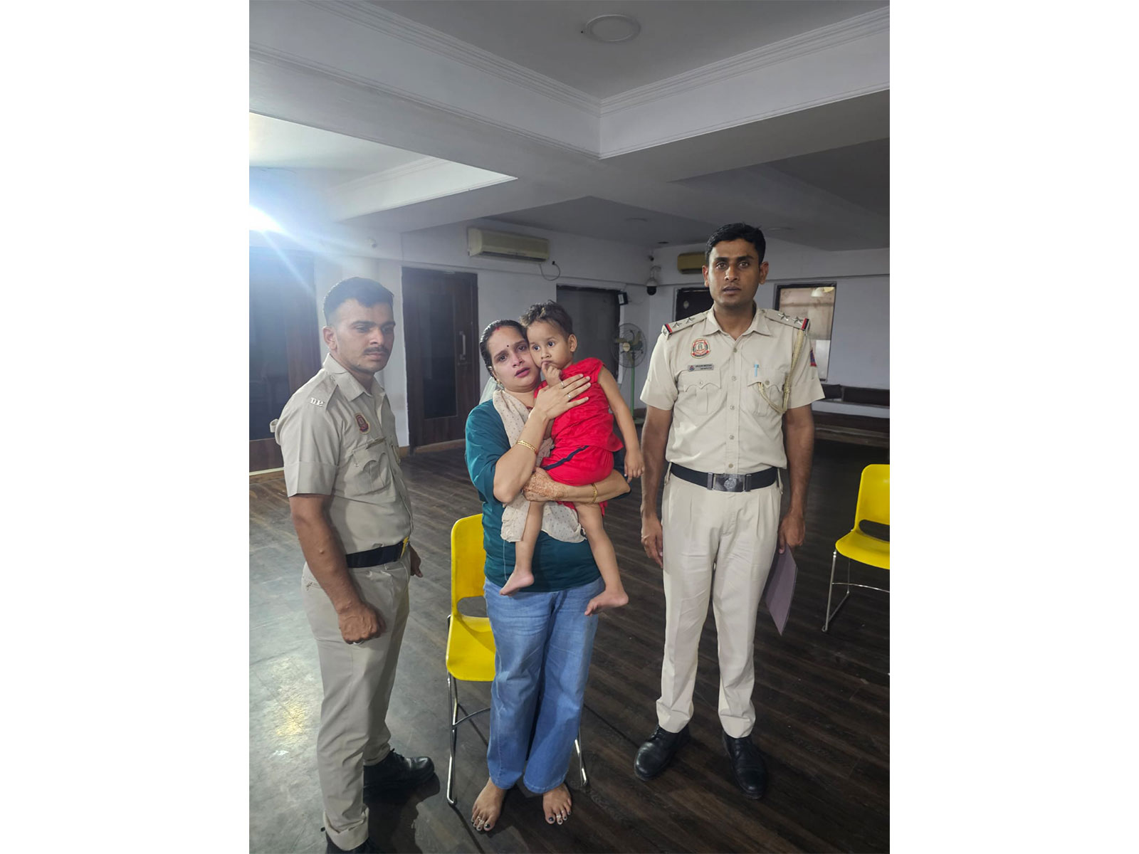 Delhi Police personnel with the child who was safely traced and reunited with his mother after going missing (Photo/ANI)