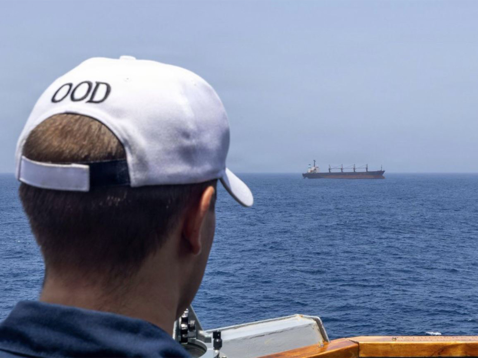 A US Navy Sailor monitors a merchant vessel in the Arabian Gulf (Photo/@CENTCOM)