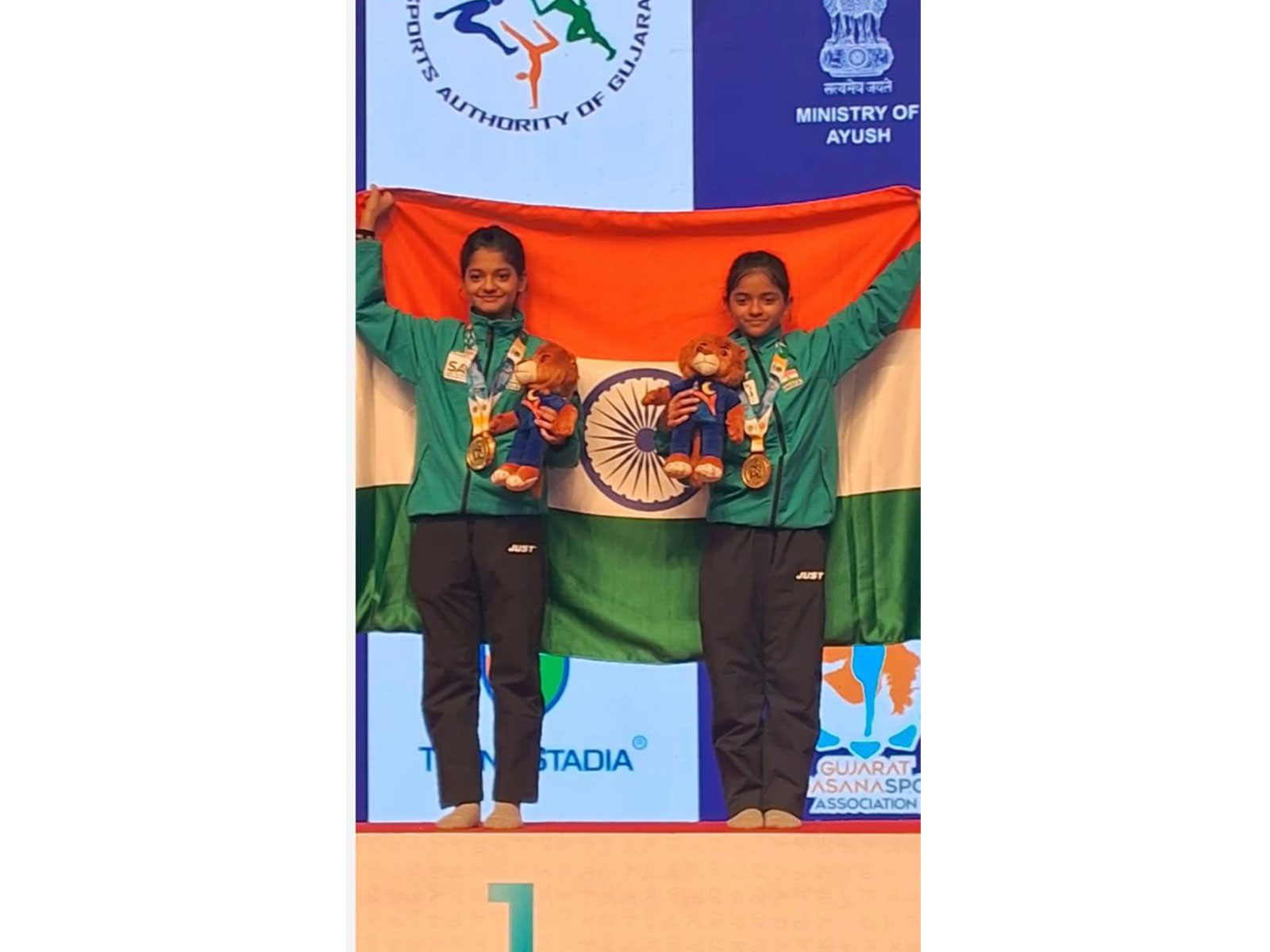 Sanwita (right) and Ishika on the victory podium during the inaugural world yogasana championships in Ahmedabad. (Photo: WYC 2026)