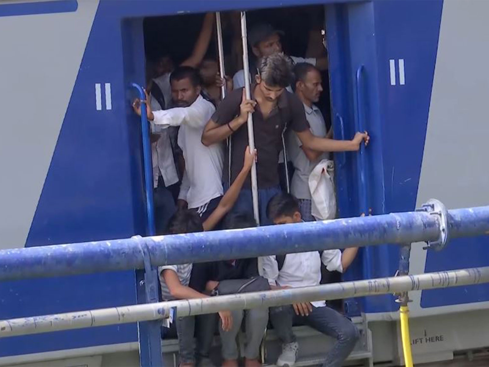 Students hang at train doors amid heavy rush (Photo/ANI)