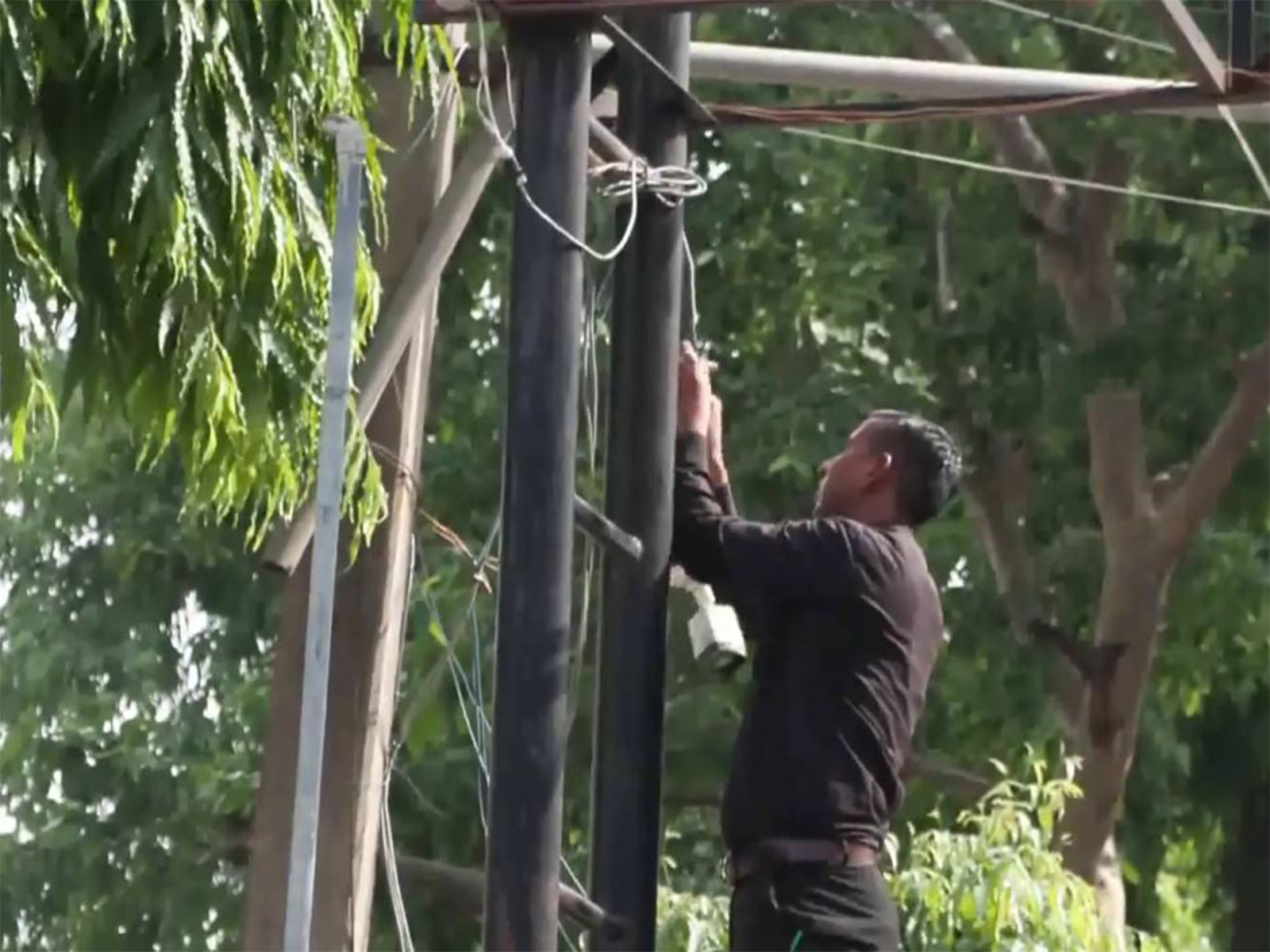 A person installing CCTV camera in an exam centre in New Delhi (Photo/ANI)