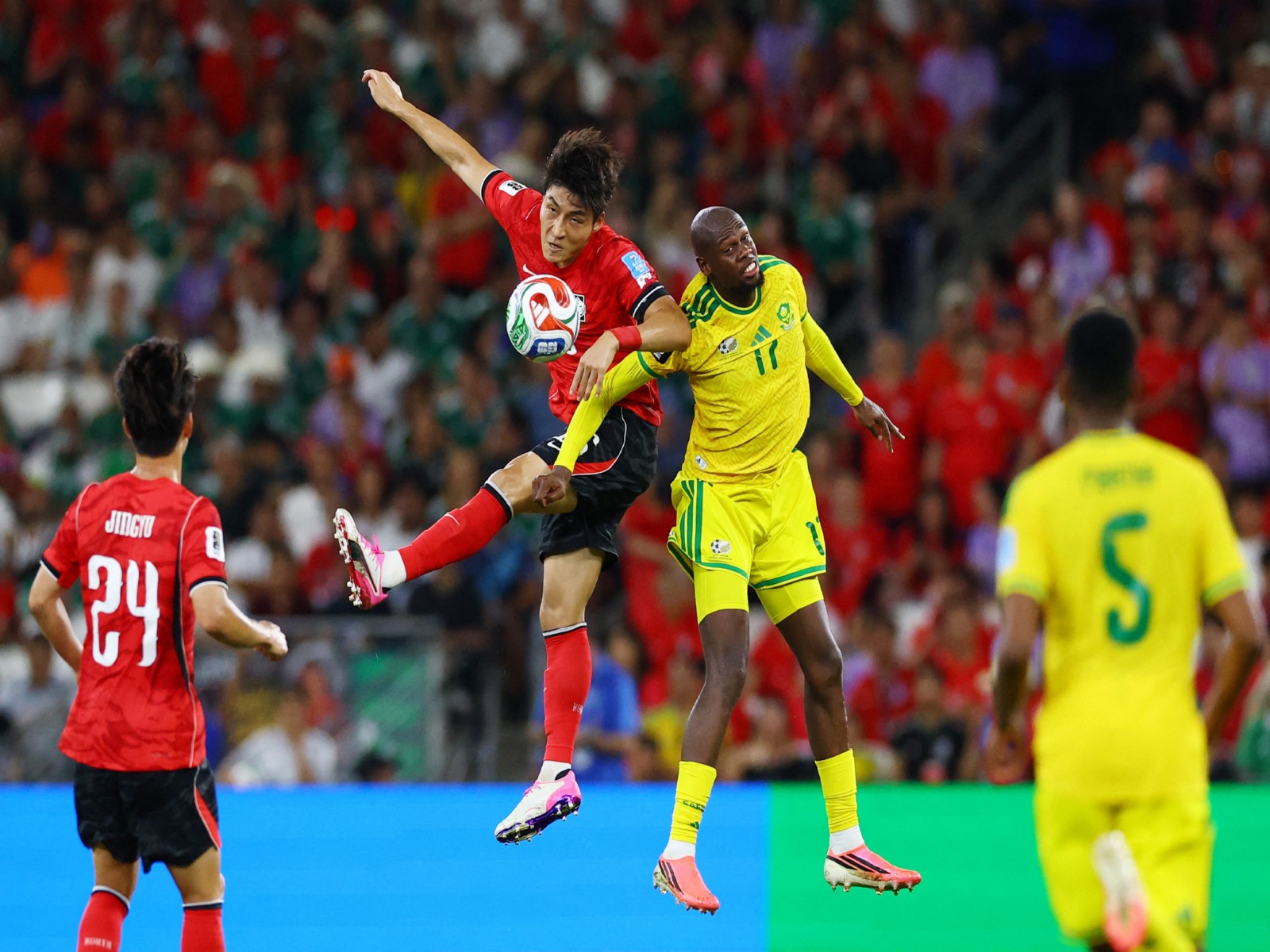 South Korea's Park Jin-Seop in action with South Africa's Evidence Makgopa. (Photo: Reuters)