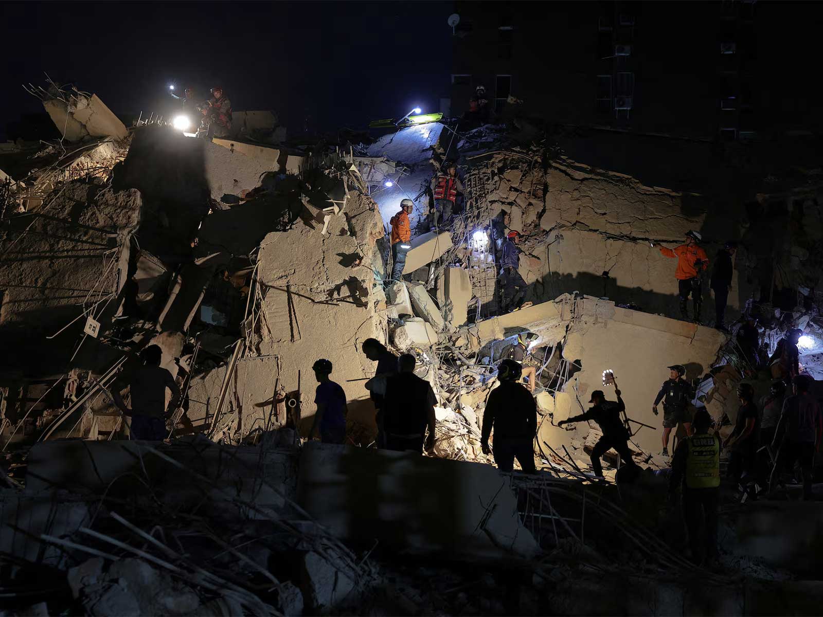 Rescue workers search through the rubble of a collapsed building following the devastating twin earthquakes in Venezuela. (Photo/Reuters)