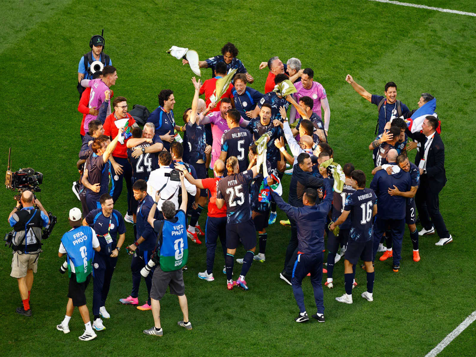 Paraguay players and staff celebrate after the match as Paraguay qualify for the Round of 16 stage of the World Cup. (Photo/Reuters) 