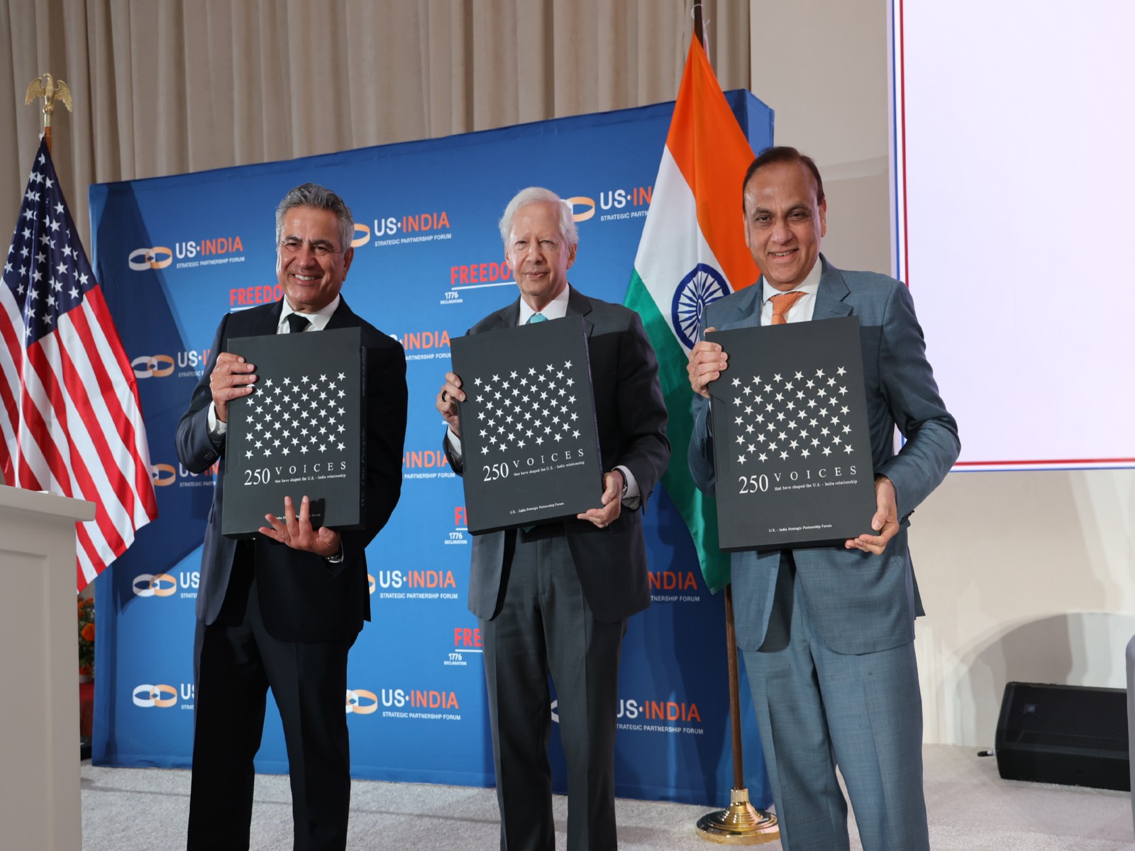 Mukesh Aghi, President and CEO of USISPF (L) and Former United States Ambassador to India Kenneth Juster (Center) with second edition of its coffee table book titled 'We The People' (Photo/X@USISPForum)