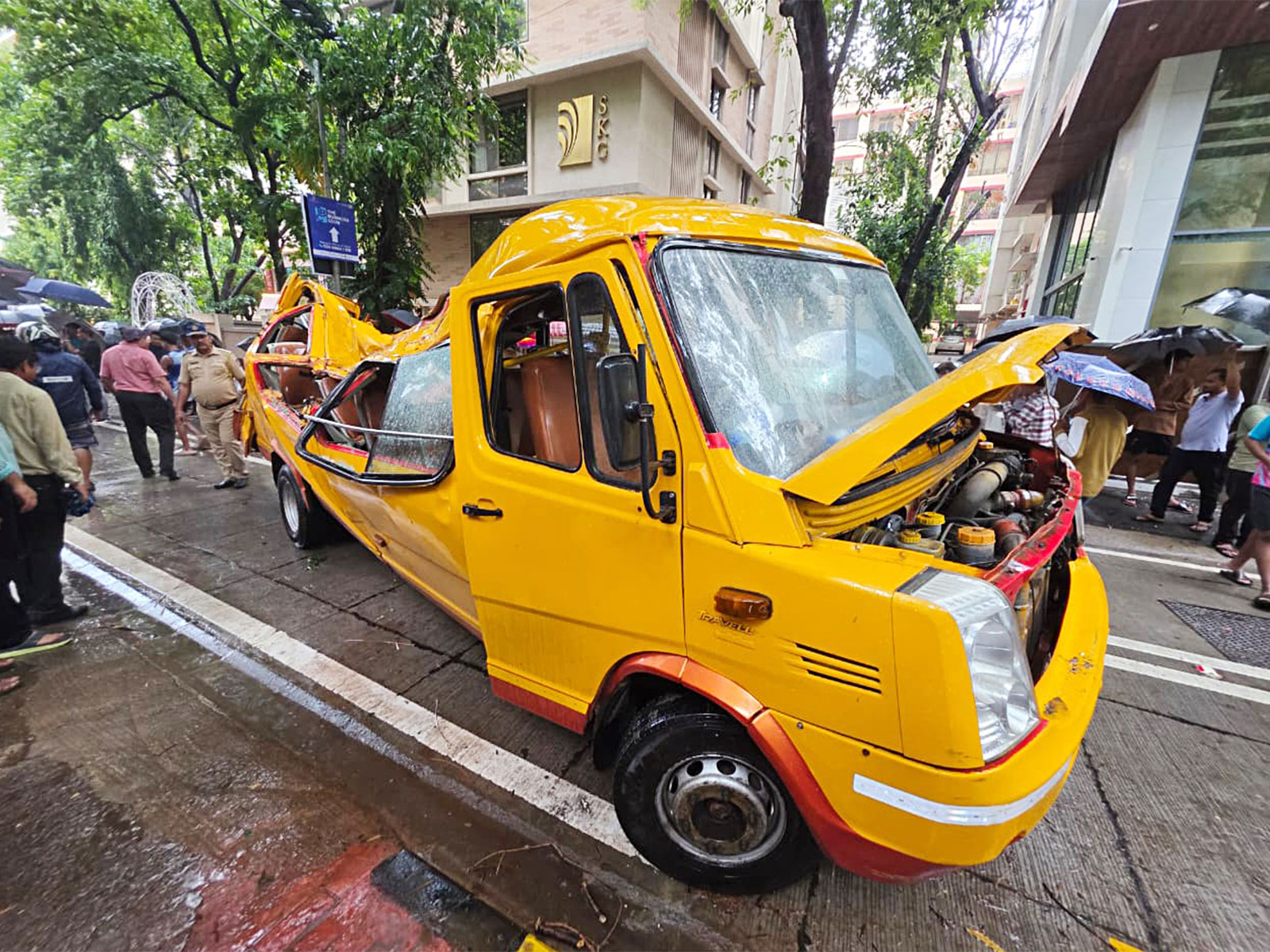 A view of the damaged school bus after a tree collapsed over it at Chembur, in Mumbai (Photo/ANI)