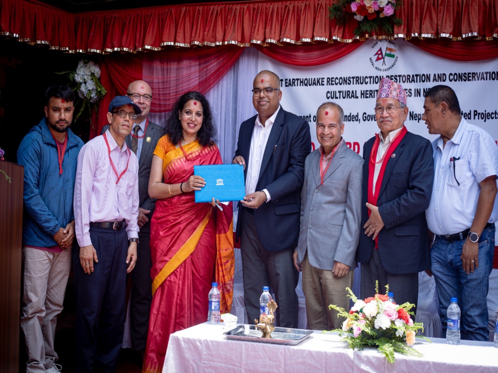 Officials present the UNESCO Asia-Pacific Award of Merit certificate to the Jestha Varna Mahavihar User Committee during a ceremony in Lalitpur, Nepal. (Image Source: Indian Embassy in Kathmandu)