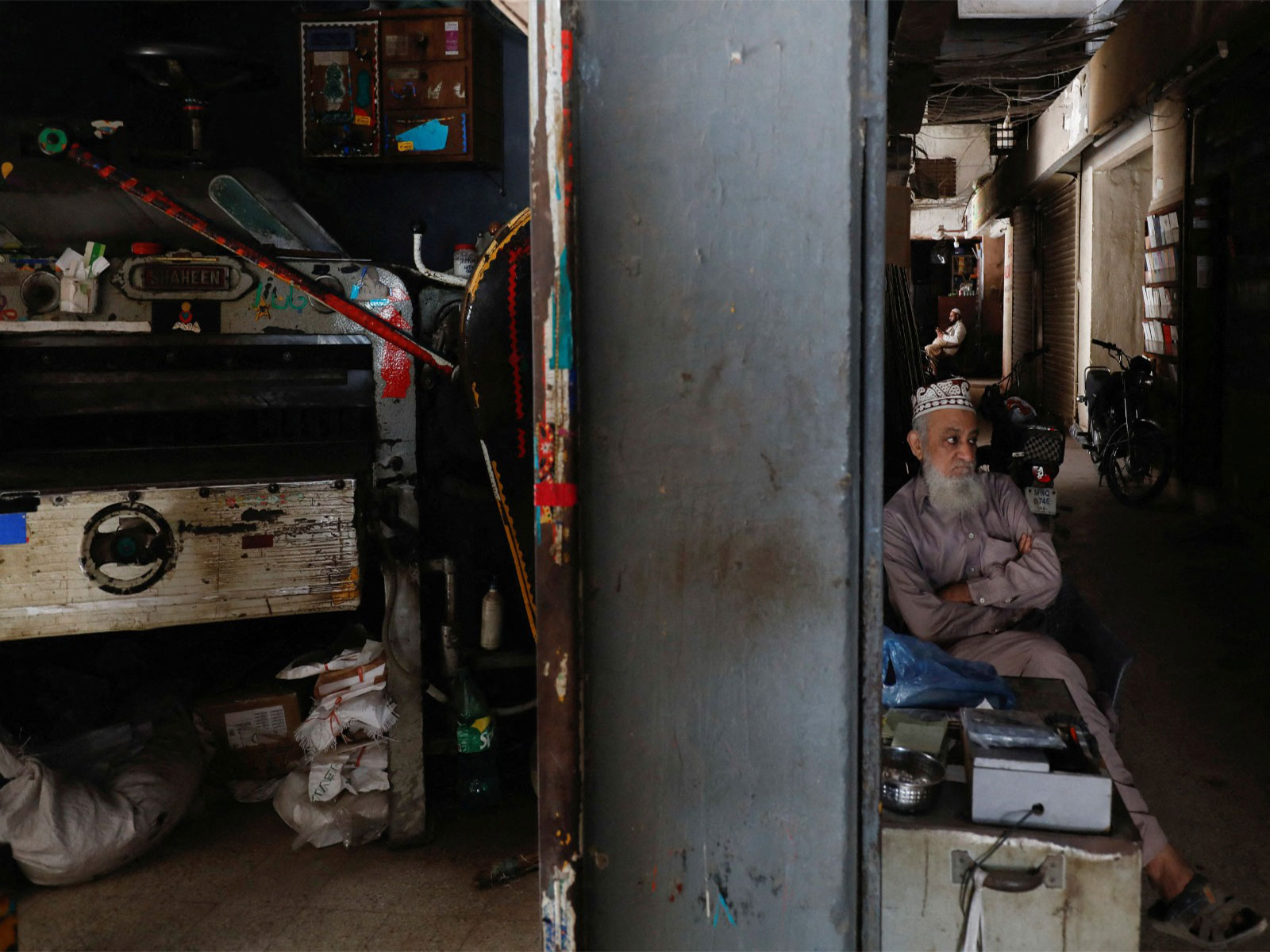 A man sits outside his shop during a country-wide power breakdown in Karachi (File Photo/ Reuters)