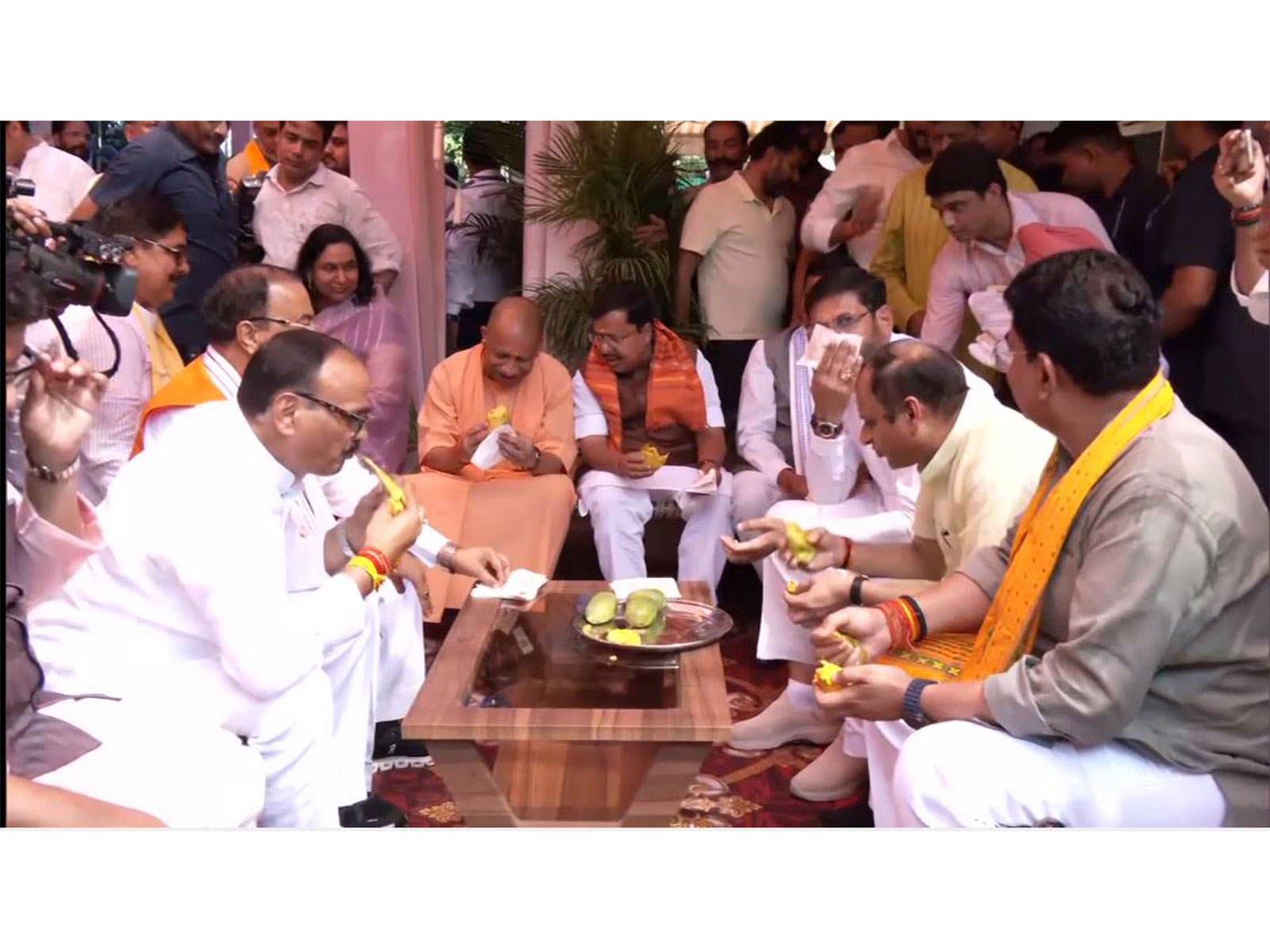 BJP leaders enjoying mangoes at Deputy CM Brijesh Pathak's residence in Lucknow. (Photo/ANI)