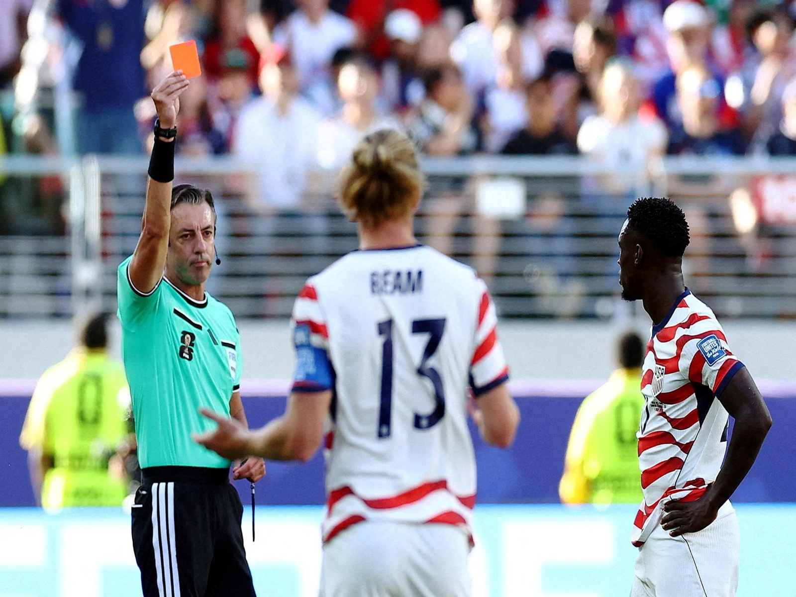 Folarin Balogun of the U.S. is shown a red card by referee. (Photo/Reuters)