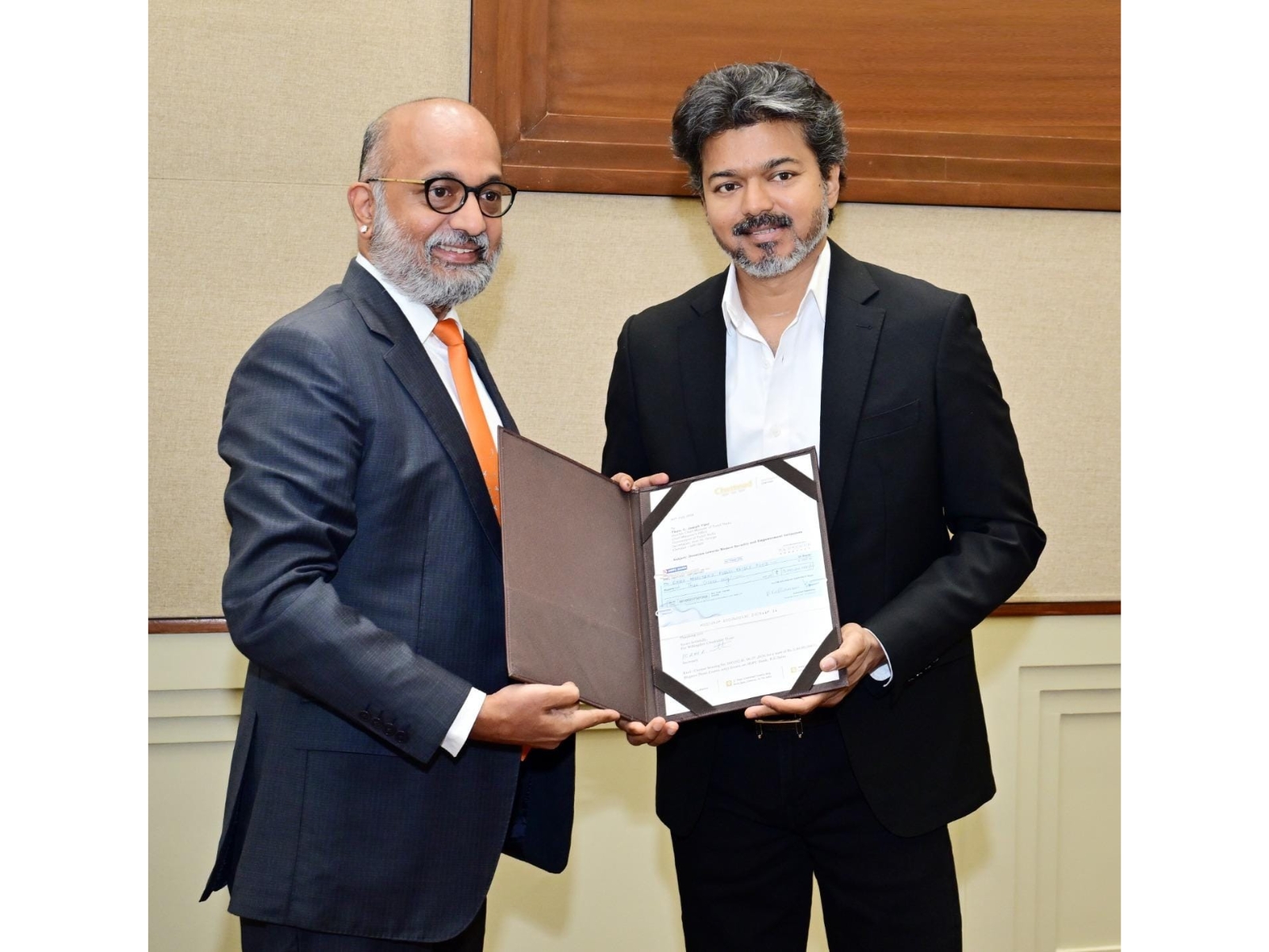 Chief Minister C. Joseph Vijay receiving the cheque from Chettinad Group managing director M.A.M.R. Muthiah at the Secretariat on Monday
