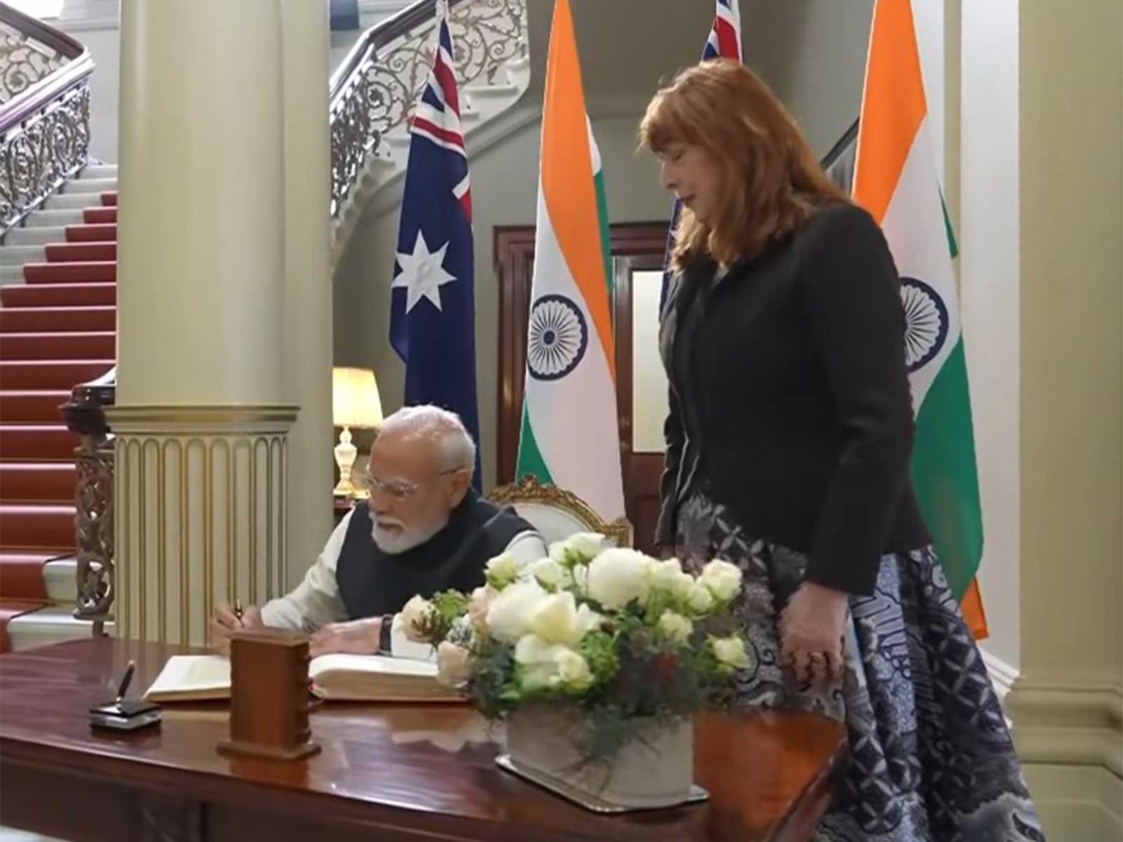 Prime Minister Narendra Modi signs Visitors' Book at Government House in Melbourne (Photo/ANI)