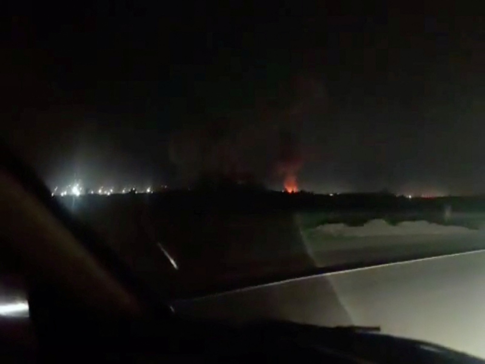 Fire and smoke rise from the direction of Iranshahr airport (Photo/Reuters)