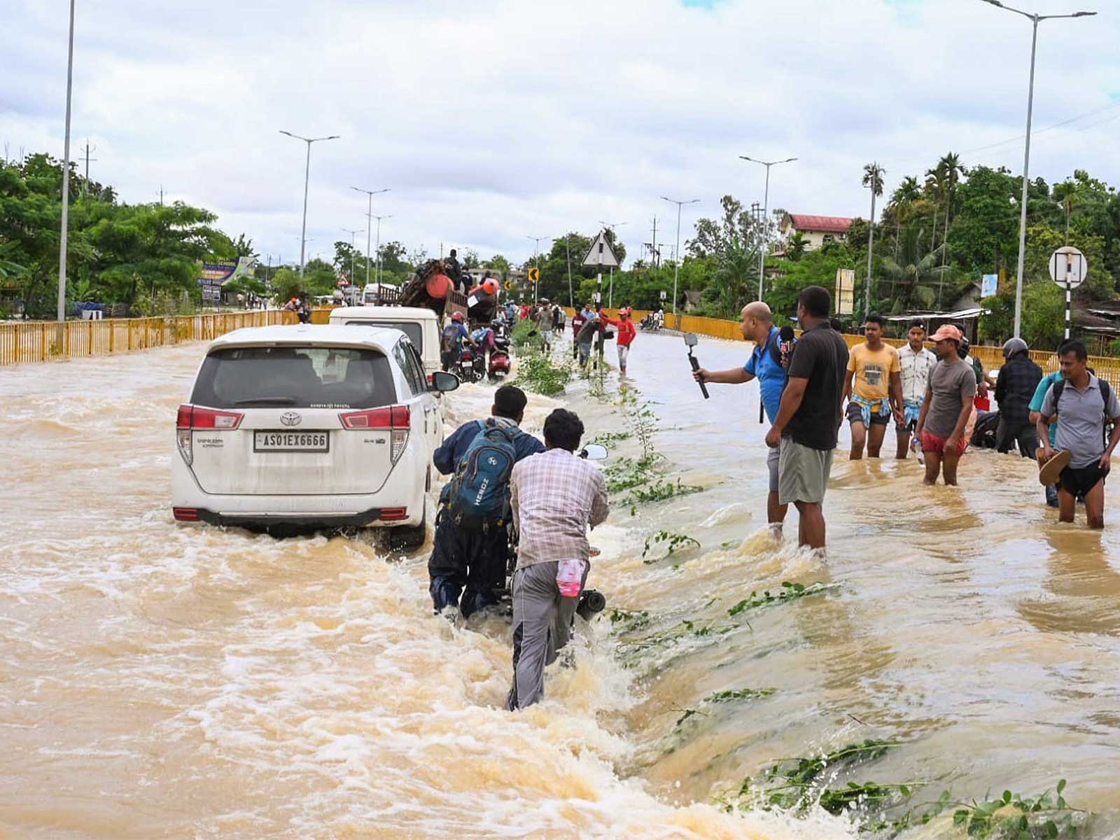 Floodwaters submerge Jorhat-Sivasagar highway in Assam, commuters struggle through waterlogged roads (Photo/ANI) 