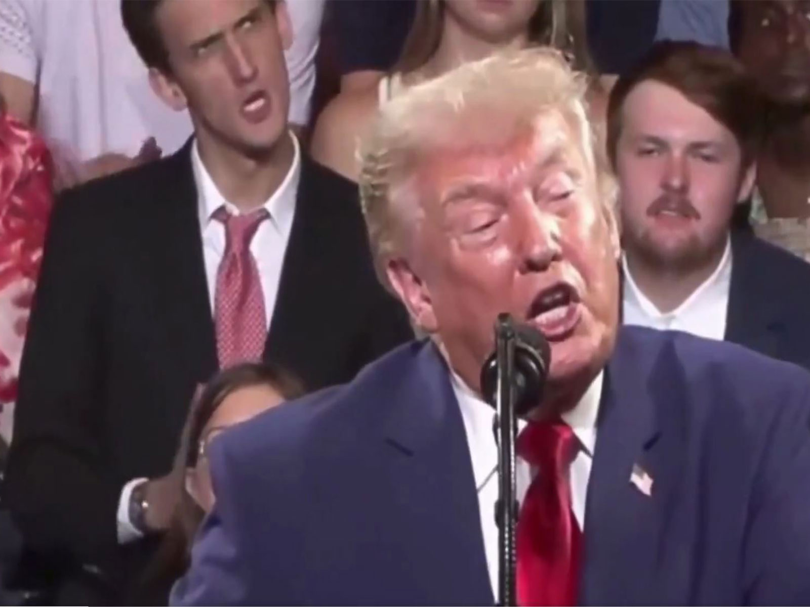 US President Donald Trump addresses supporters at Wheeler High School in Marietta, Georgia, as an audience member seated behind him appears to mimic his gestures. (Photo/YouTube)