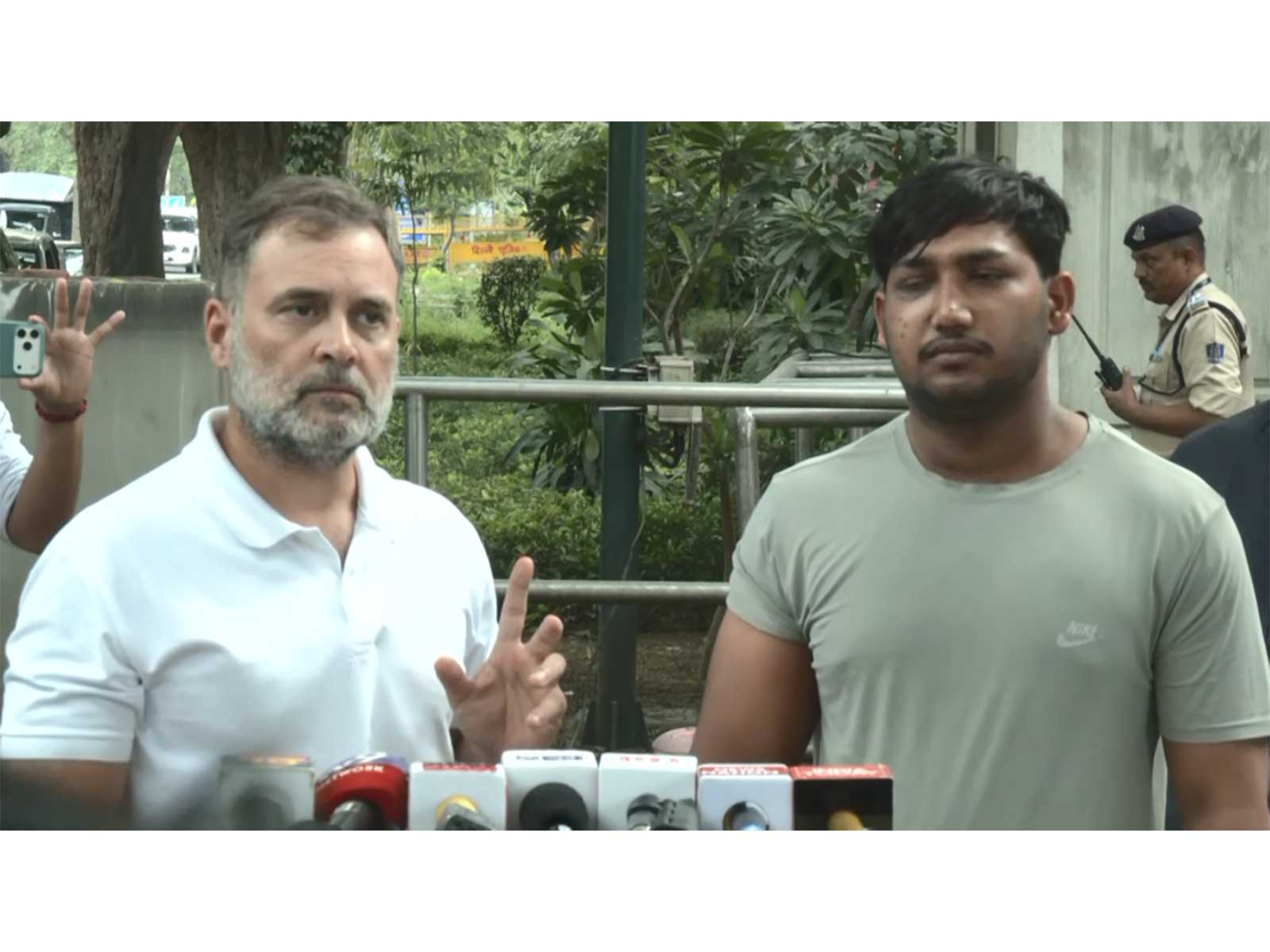 Rahul Gandhi with a youth protester (Photo/ANI)