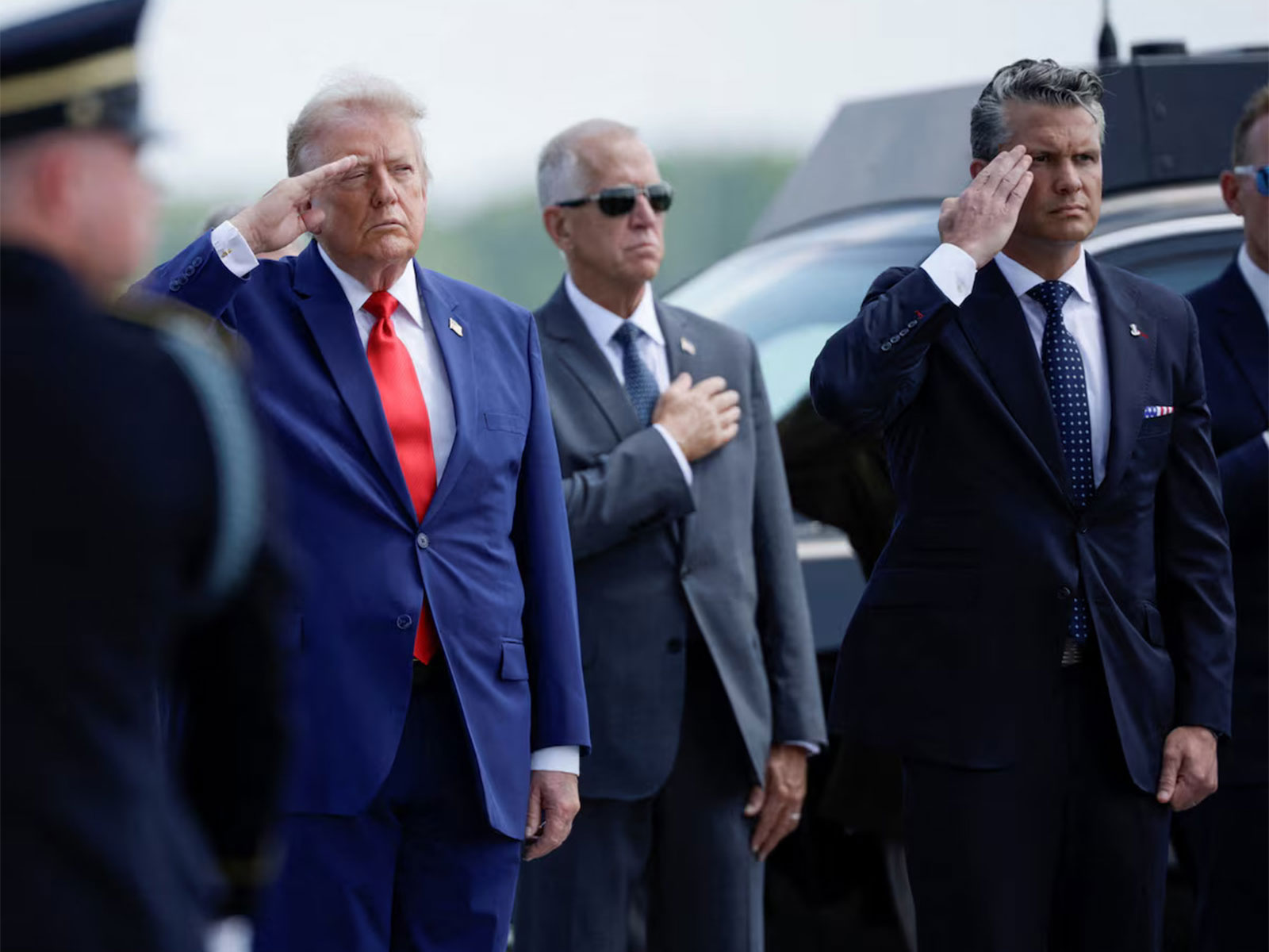 US President Donald Trump and US Secretary of War Pete Hegseth salute during a dignified transfer at Dover Air Force Base. (Photo/Reuters)