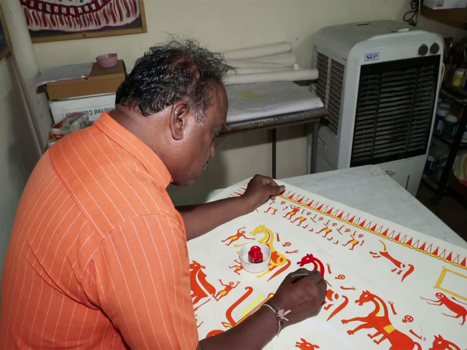 An artist working on Pithora painting (Photo/ANI)