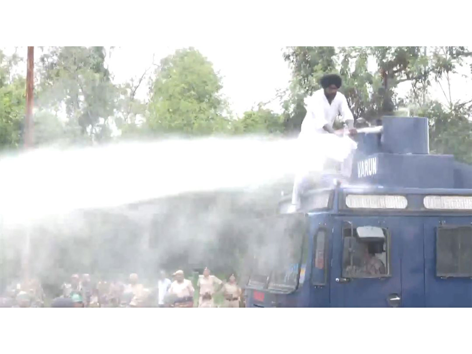 Akali Dal Waris Punjab De worker climbs over a water cannon vehicle during a protest (Photo/ANI)