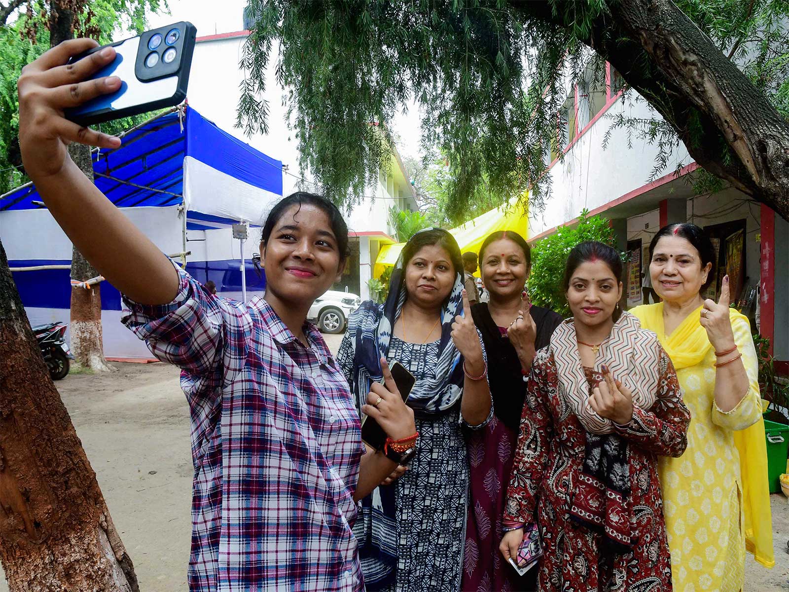 Voters pose showing ink-marked finger after casting their vote in Bankipur (Photo/ANI)