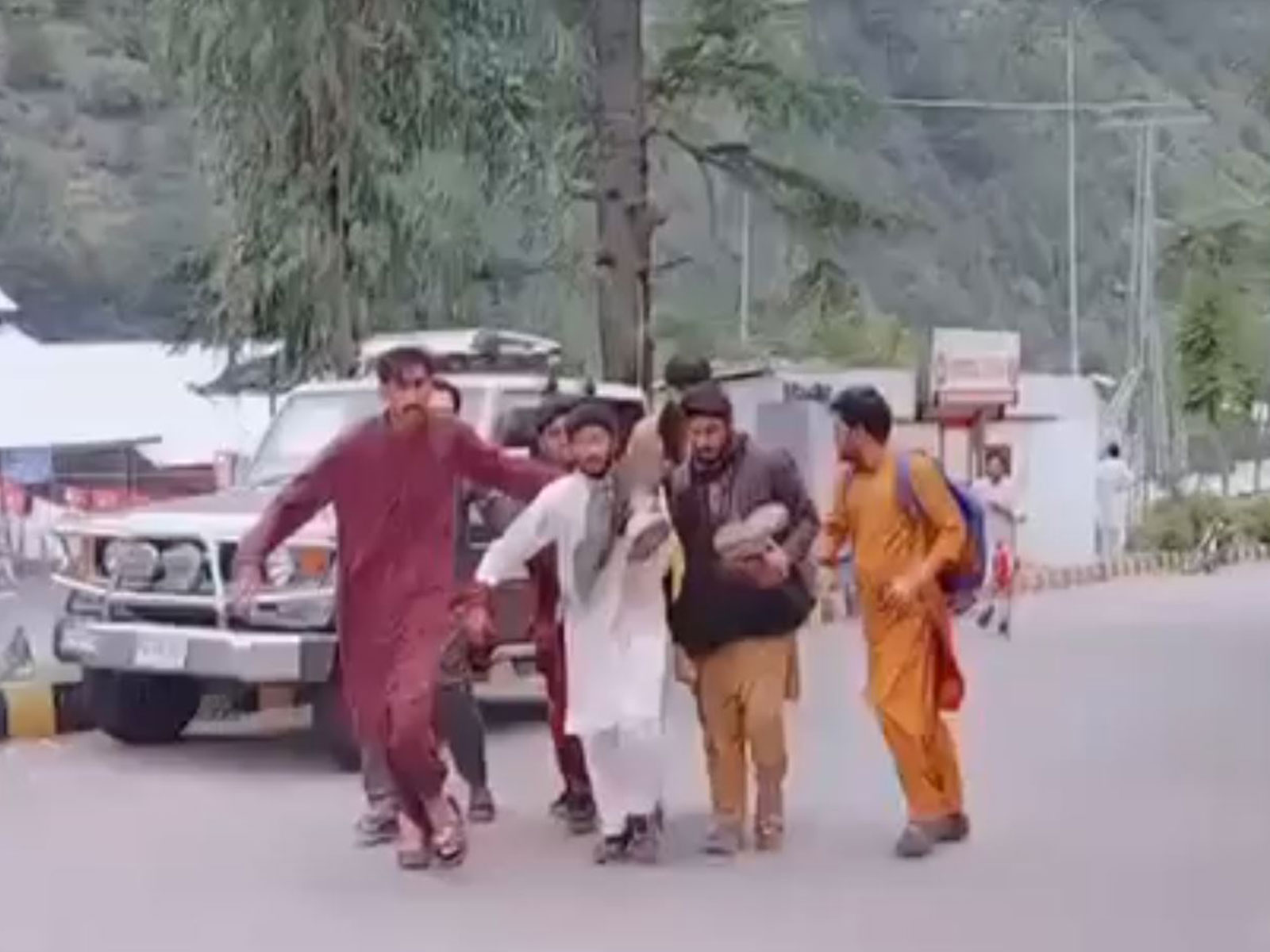 Residents carry an injured protester after security forces reportedly opened fire during demonstrations in Athmuqam Tehsil, Neelum Valley, amid the second phase of the so-called legislative elections in Pakistan-occupied Jammu and Kashmir (PoJK) on S