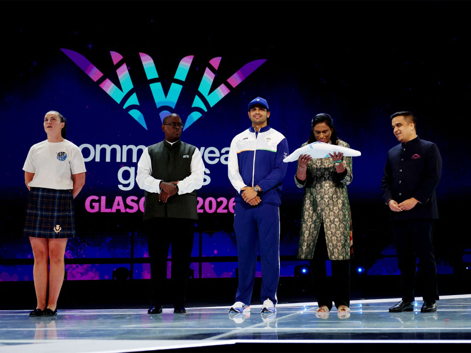 Neeraj Chopra, PT Usha and Gujarat deputy chief minister Harsh Sanghavi receive the flag during the closing ceremony. (Photo/Reuters) 