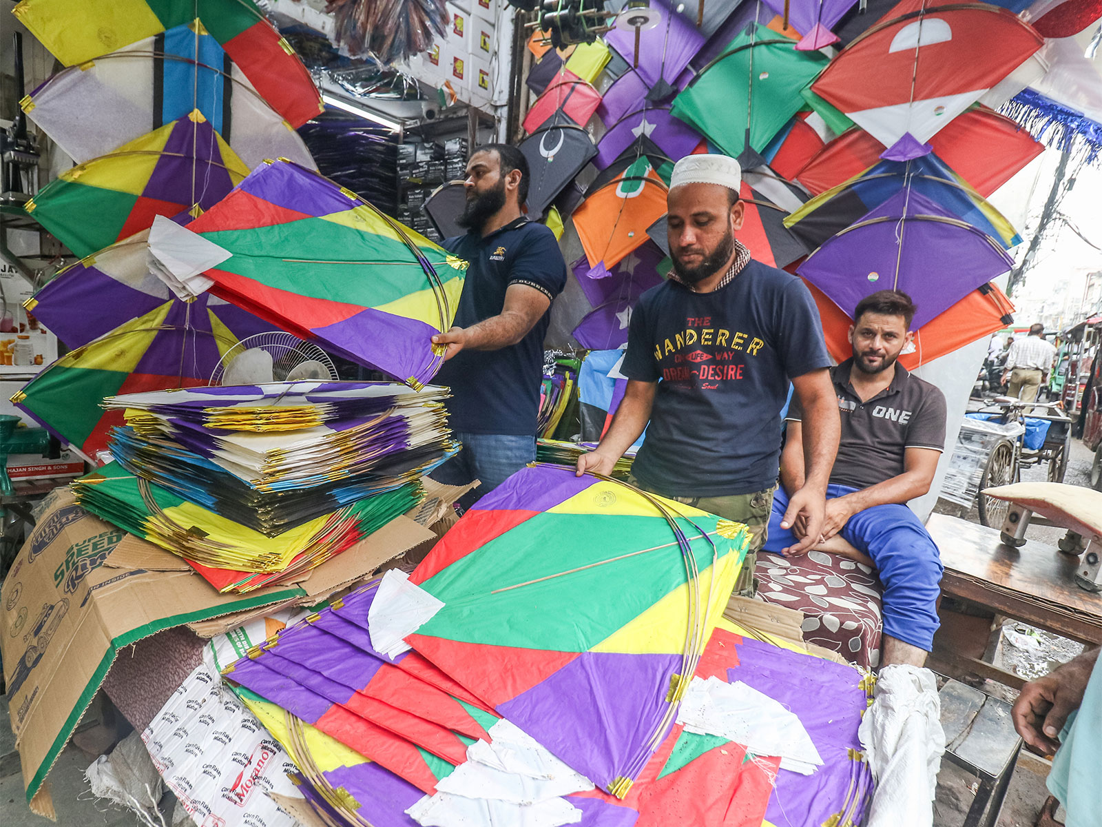 Vendors arrange the kites to sell ahead of the Independence Day celebration at Lal Kuan Bazaar, in Old Delhi (Photo/ANI)