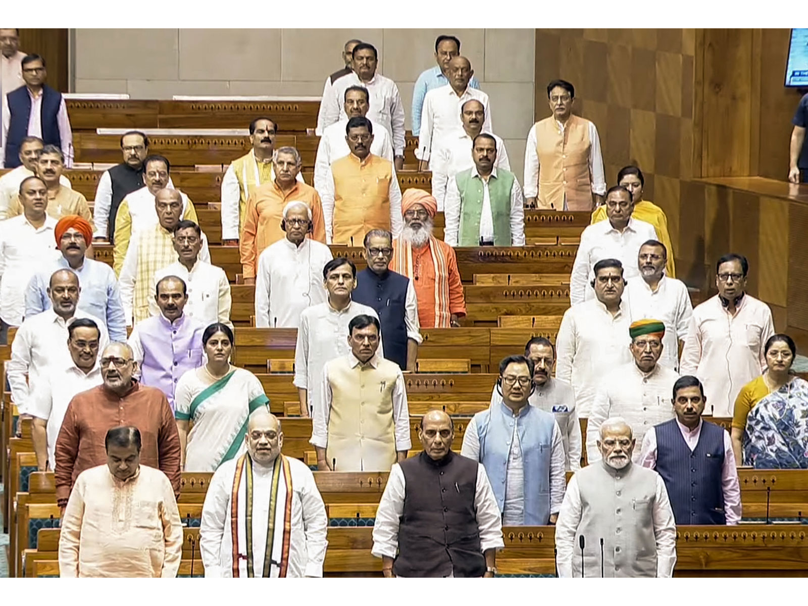 Prime Minister Narendra Modi stands for 'Vande Mataram' in Lok Sabha during the Monsoon Session in New Delhi on Thursday. Union Ministers Amit Shah, Rajnath Singh and others are also present (Photo: Sansad TV)