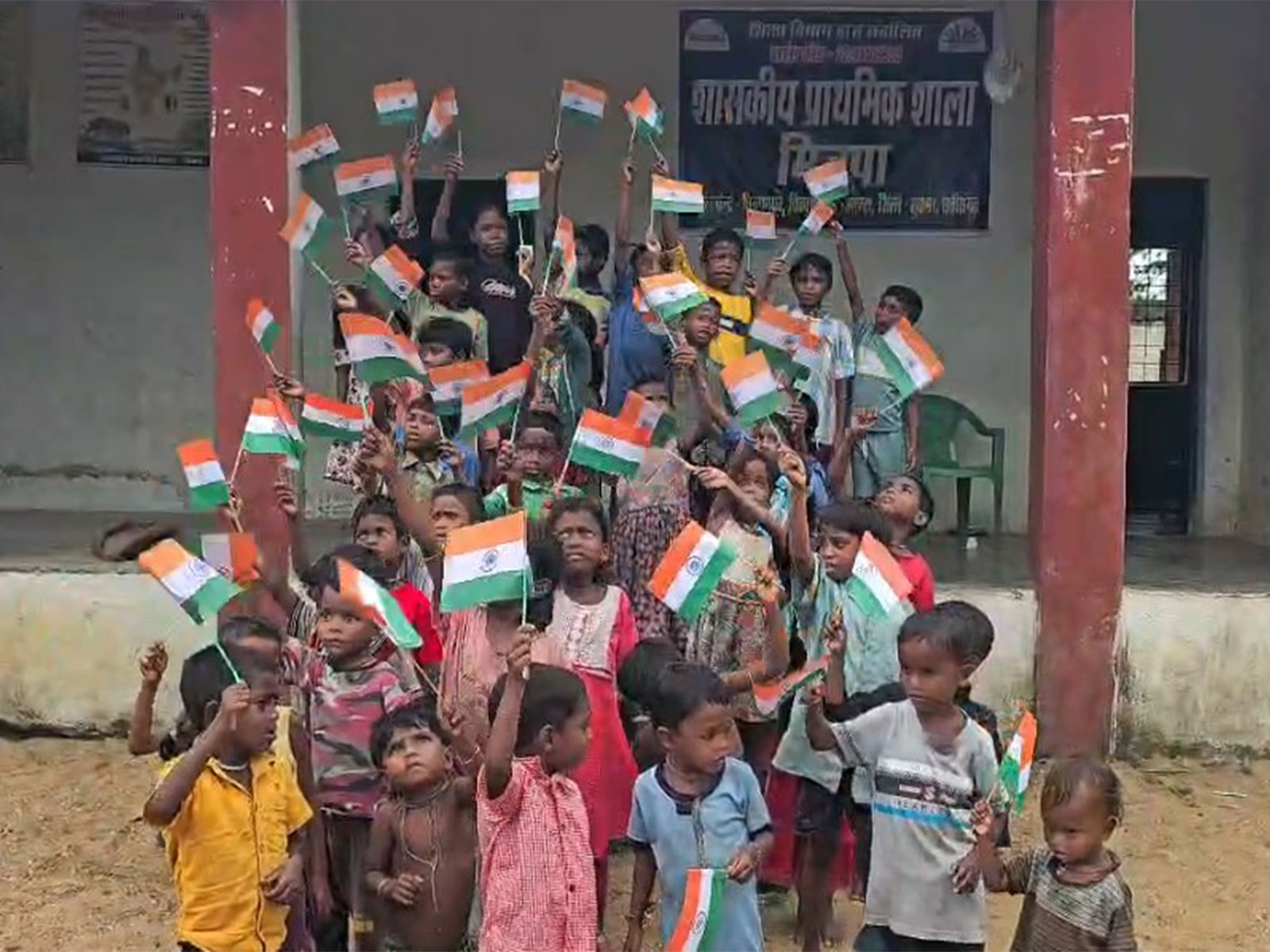 Village children in Minpa wave National Flag (Photo/ANI)