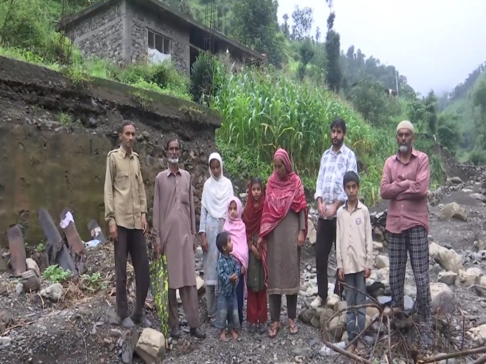 A family, whose house got washed away in the flash flood (Photo: ANI)