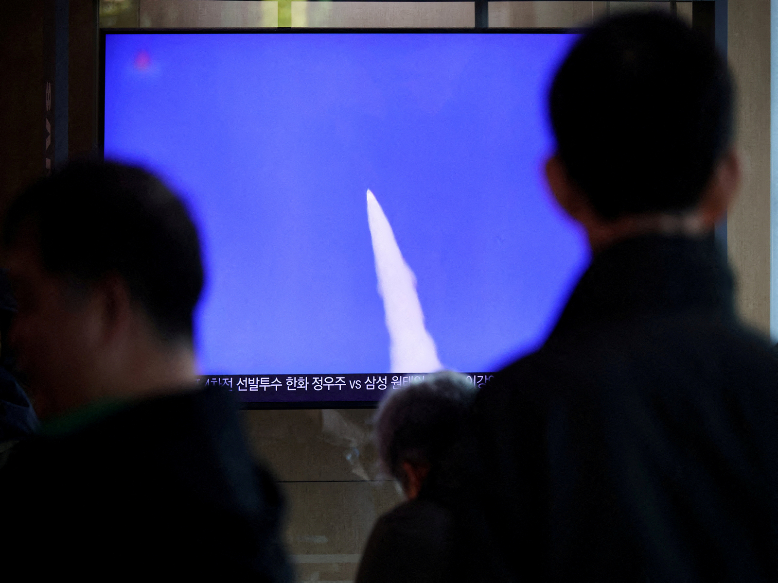 A file photo of people watching a TV broadcasting a news report on North Korea firing short-range ballistic missiles (File Photo/ Reuters)