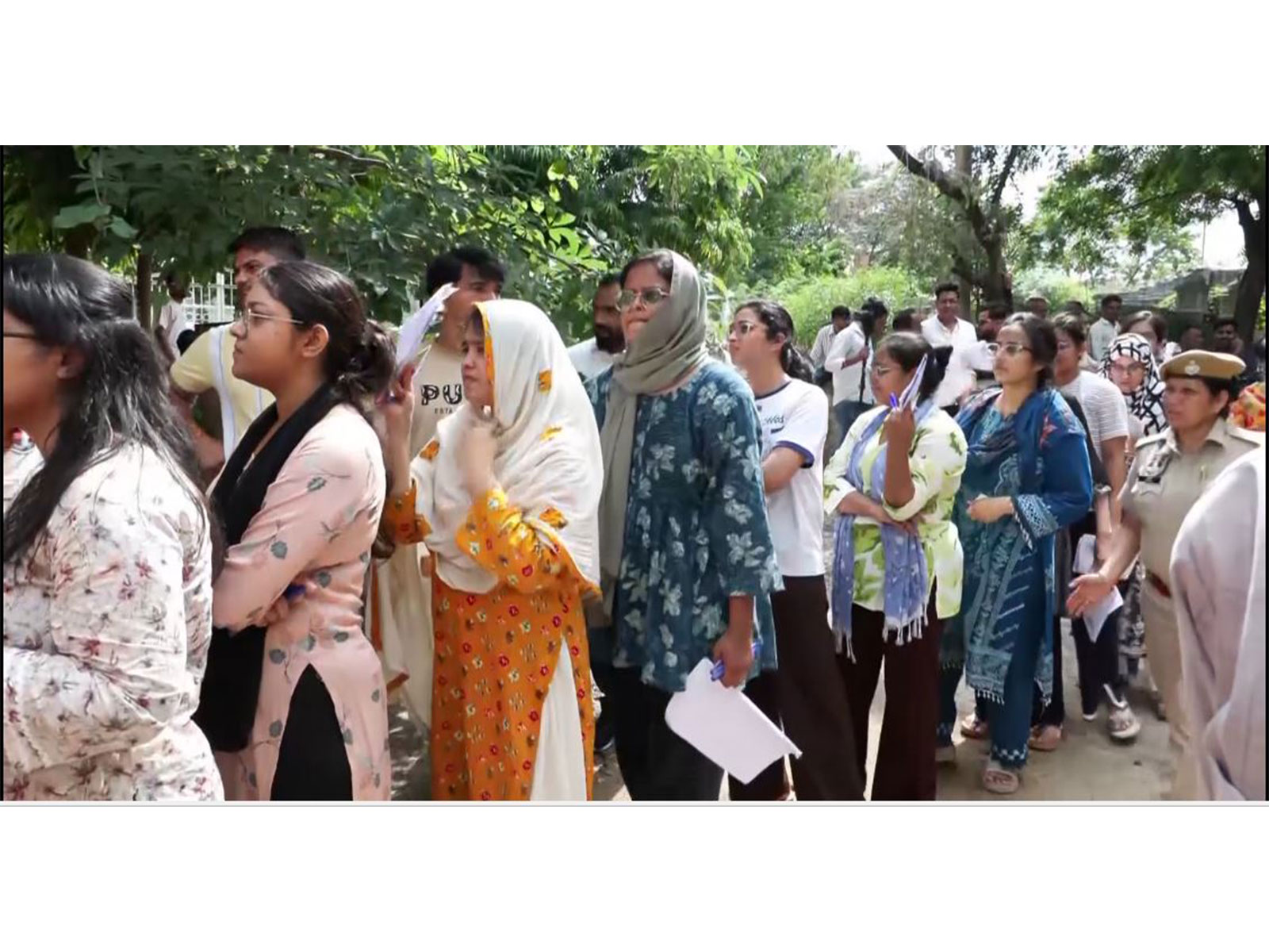 Candidates gather outside the Satya Sai PG Girls College examination center (Photo/ANI)