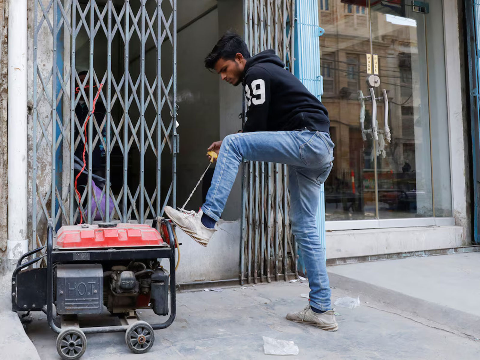 A man operates a generator outside his shop amid a nationwide power outage in Karachi, Pakistan. (Photo/Reuters)