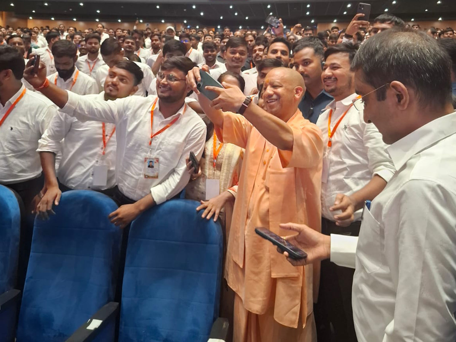 UP Chief Minister Yogi Adityanath takes selfies with youth after an appointment letter distribution event in Lucknow (Photo/ANI)