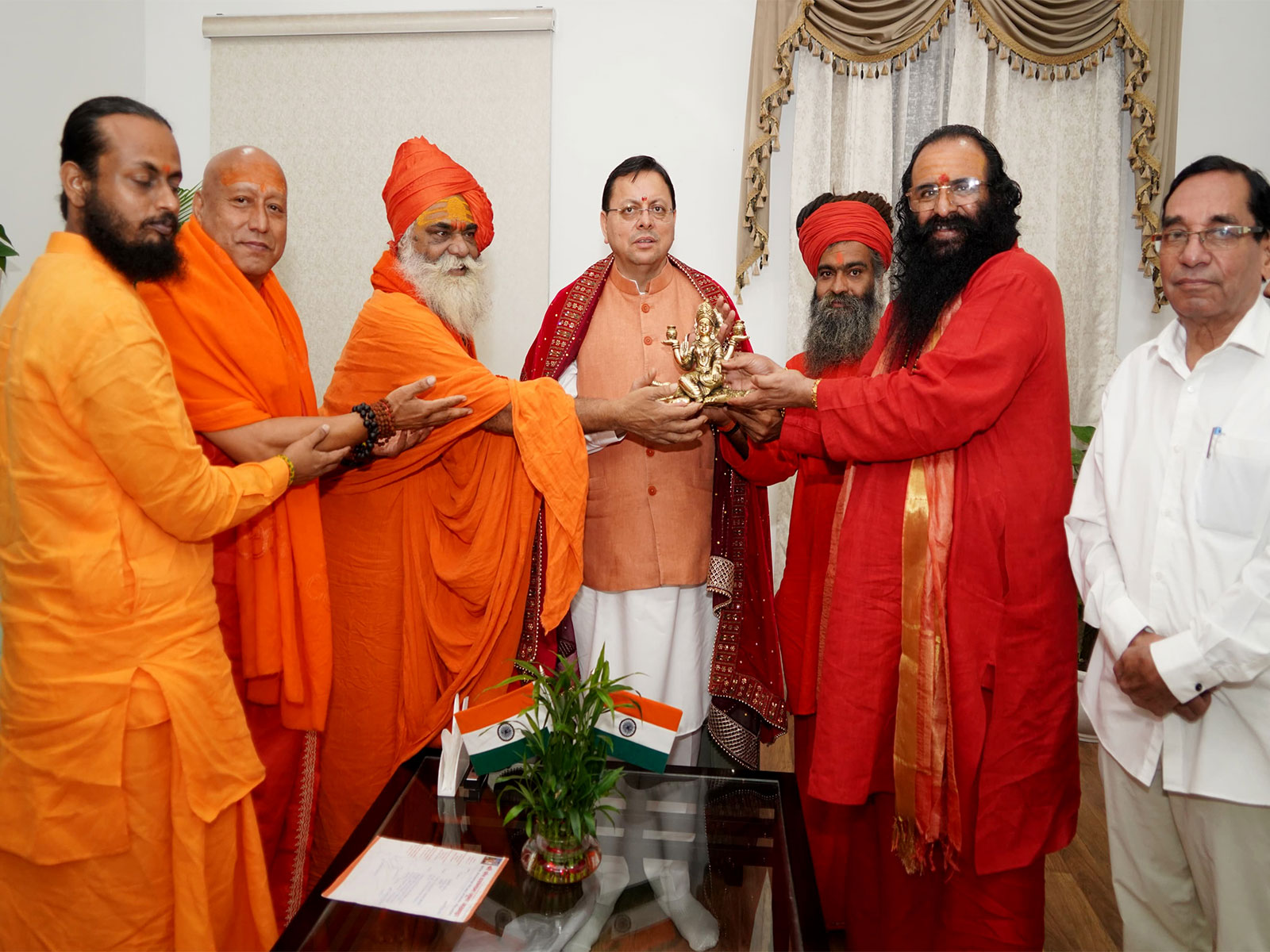 CM Pushkar Singh Dhami meets saints led by Mahant Ravindra Puri Maharaj (Photo/ANI)
