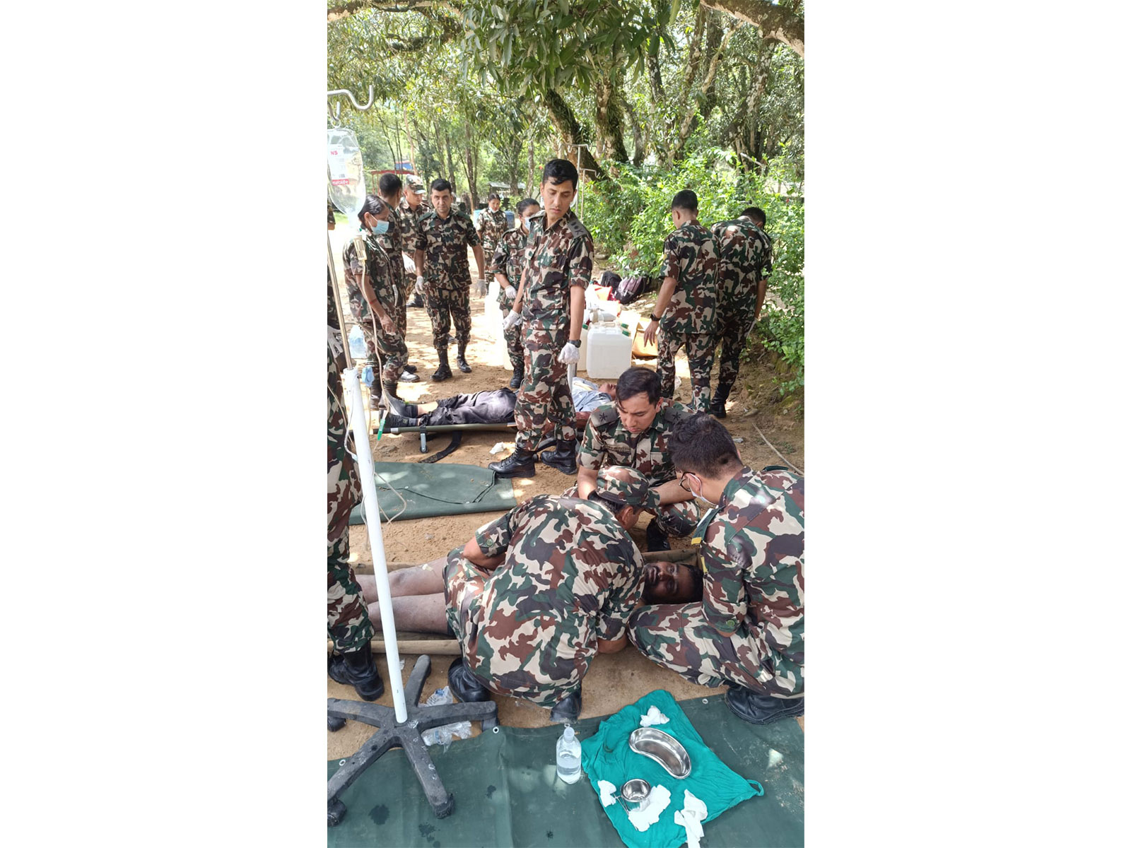 Nepali security personnel and medical staff provide emergency treatment and first aid to injured individuals following a sudden flood caused by an outburst in the Bhotekoshi River in the Rasuwa District. (Image Source: Nepal PMO)