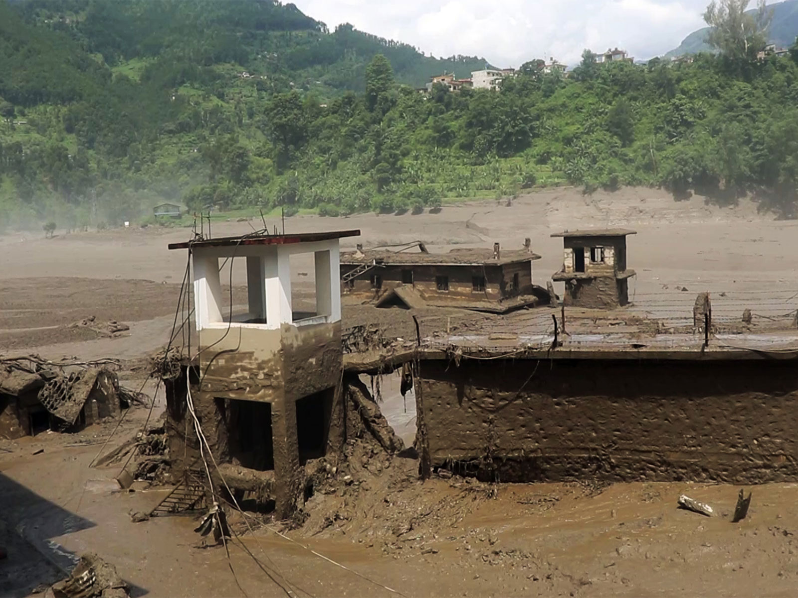 An area devastated by mud-laden floodwaters following a flash flood caused by an outburst in the Bhotekoshi River, in Nepal's Rasuwa (Photo/ANI)