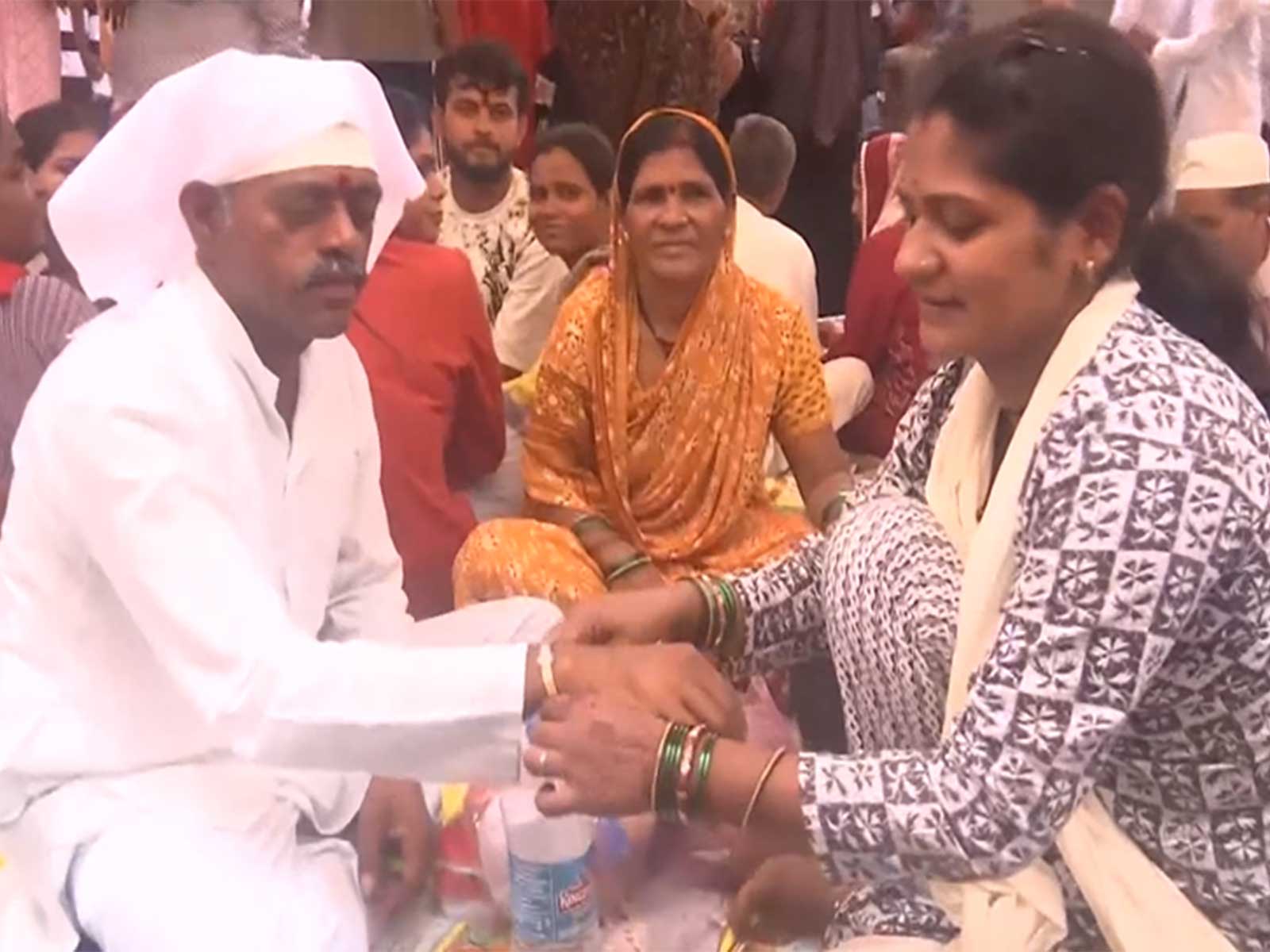 Woman is tying Rakhi to inmate brother (Photo/ANI)
