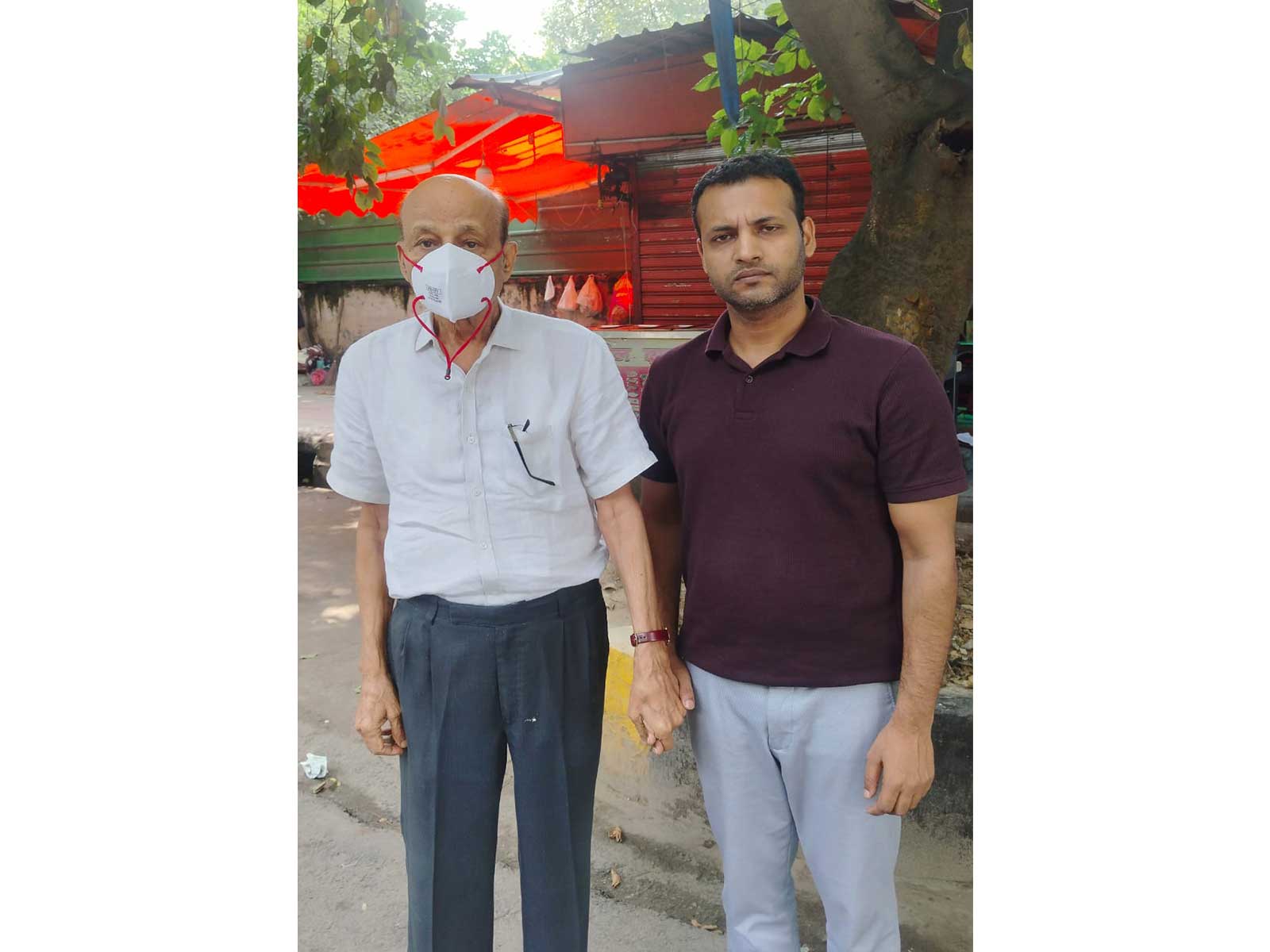 Hariram, the owner of the building that collapsed in Satya Niketan with a Delhi Police official (Photo/ANI)