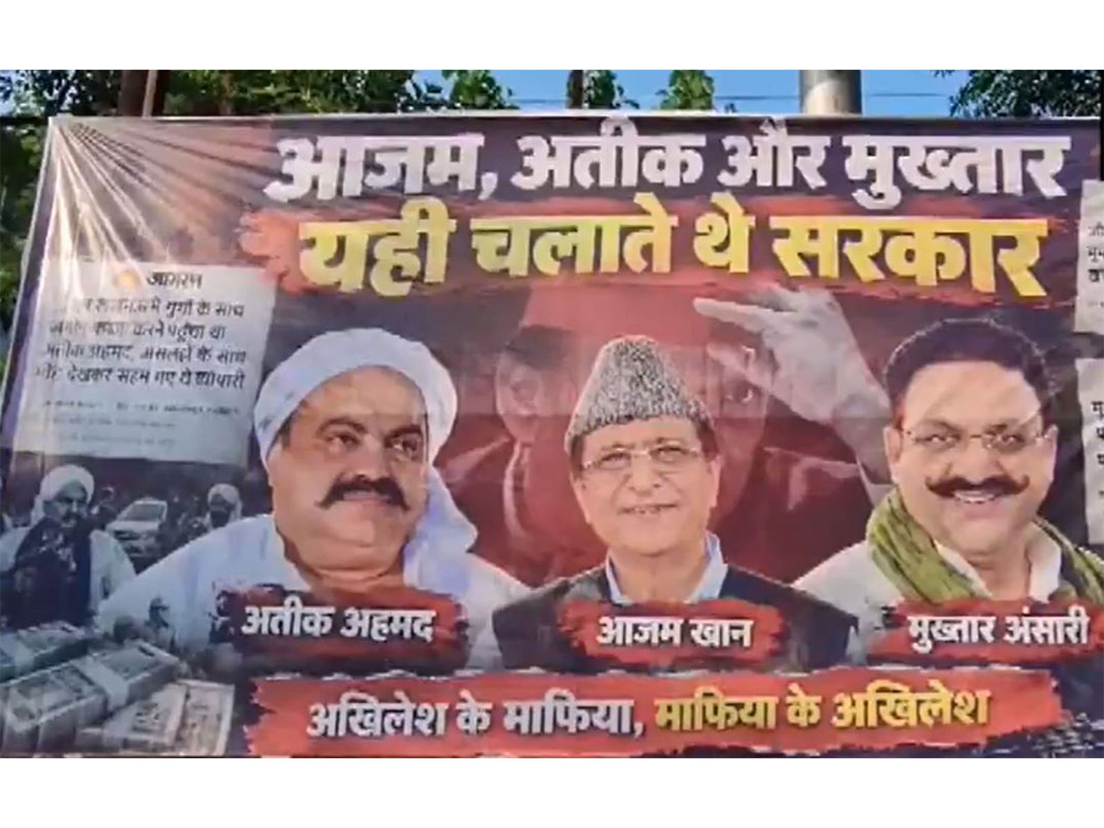 A poster featuring pictures of Atiq Ahmed, Azam Khan and Mukhtar Ansari, with a message targeting Samajwadi Party chief Akhilesh Yadav, seen in Lucknow. (Photo: ANI)