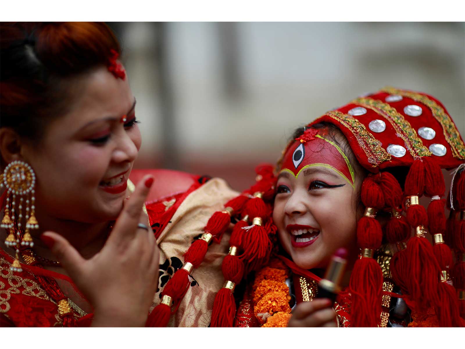 A young girl dressed as the Living Goddess Kumari smiles during the Kumari Puja festival in Kathmandu (File Photo/Reuters)