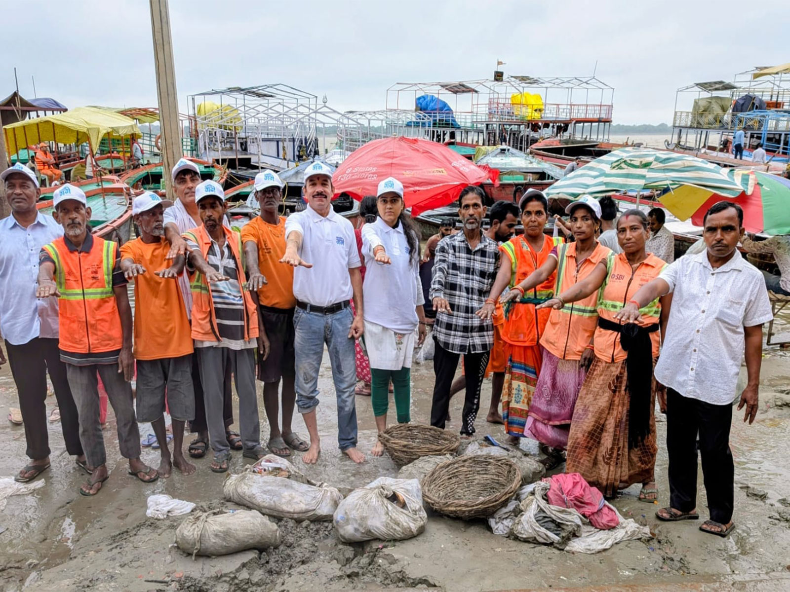 Namami Gange and Varanasi Municipal Corporation teams carry out a cleanliness drive at Dashashwamedh Ghat following the recent floods, removing more than one tonne of waste from the Ganga. (Photo: ANI)
