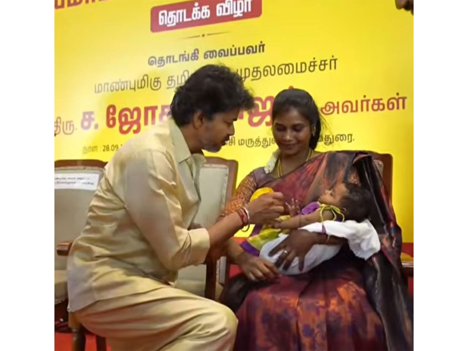 Tamil Nadu Chief Minister C. Joseph Vijay presents a Gold ring to a newborn child (Photo/TNDIPR)