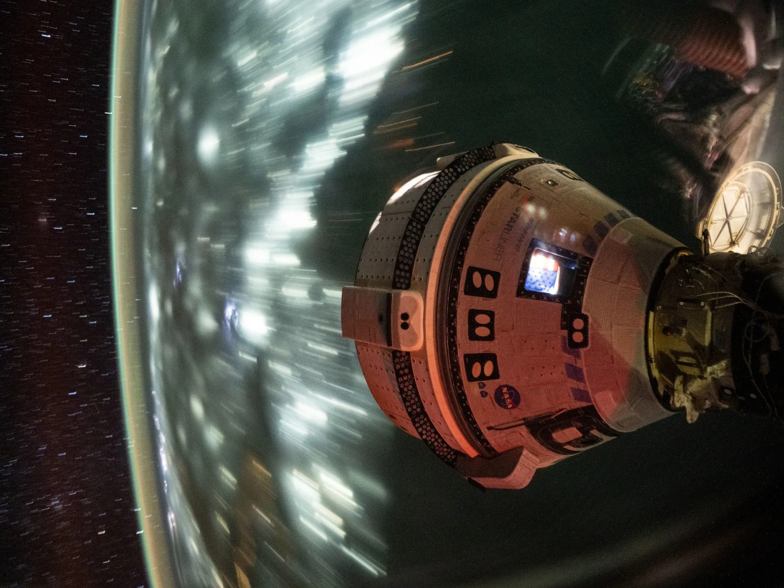 Boeing’s Starliner spacecraft docked to the International Space Station's Harmony module, captured from orbit on July 3, 2024. (Image Source: NASA)