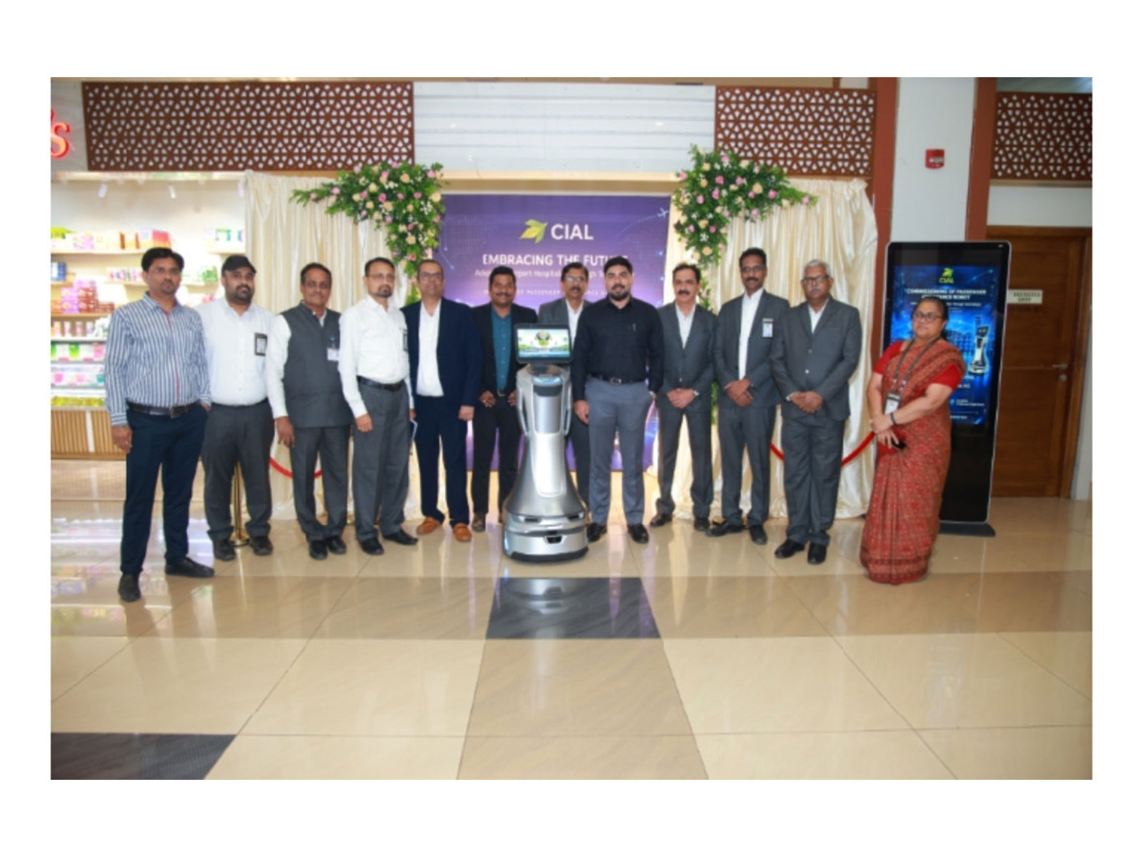Kinetiq Robotics and Cochin International Airport Limited representatives gather with Nova, the AI-driven service robot, to mark its passenger-facing debut.