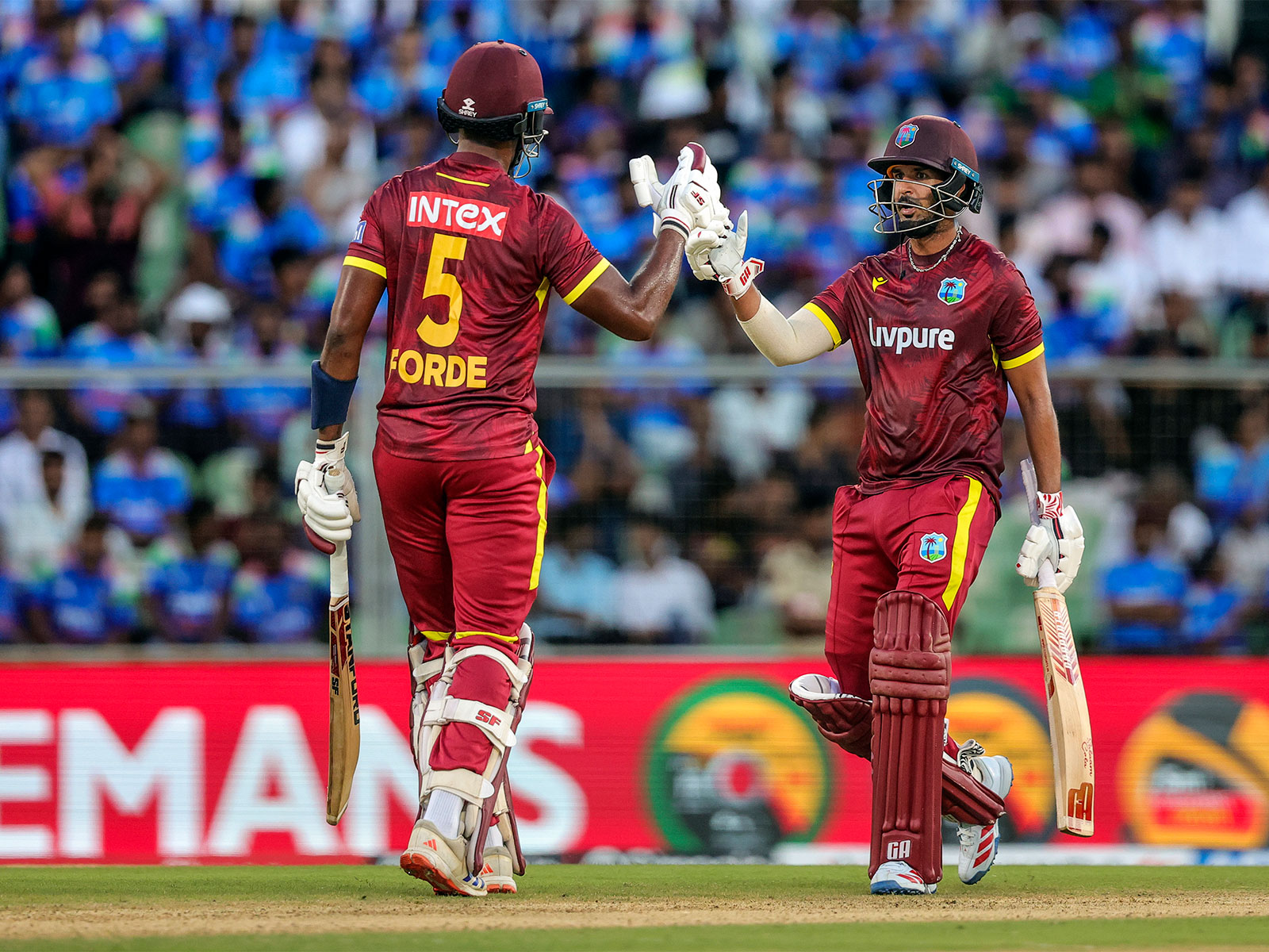 West Indies' Amir Jangoo (R) celebrates his half century with teammate Matthew Forde. (Photo/ANI)